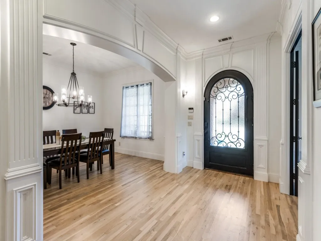 Foyer entrance featuring architectural detailing, light wood flooring and tons of light.