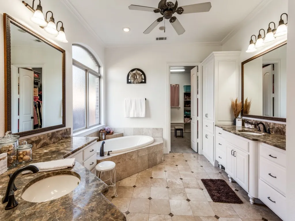 Primary bath features dual sinks, soaking tub and tons of storage.