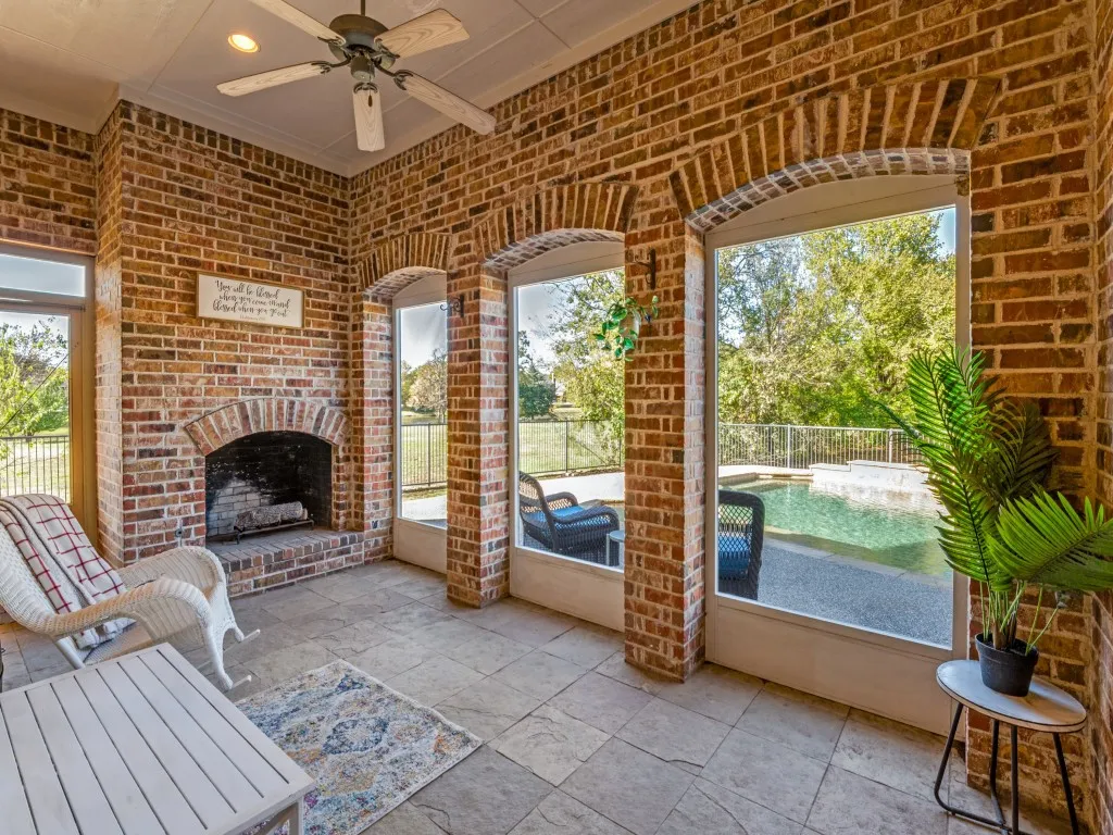 Sunroom features tile flooring and fireplace for year around use.