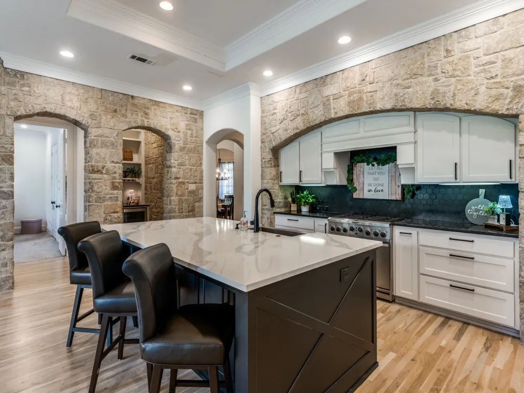 Updated kitchen with gorgeous quartz island, stainless gourmet appliances, under counter lighting and coffee wine bar grotto.