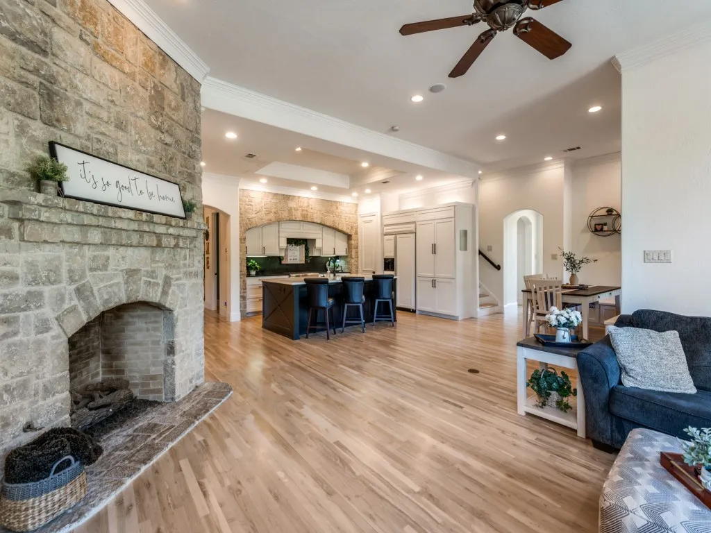 Open floor plan has so much space for entertaining or lounging together. Gorgeous stone corner fireplace ready to provide warmth and more coziness in the winter too!
