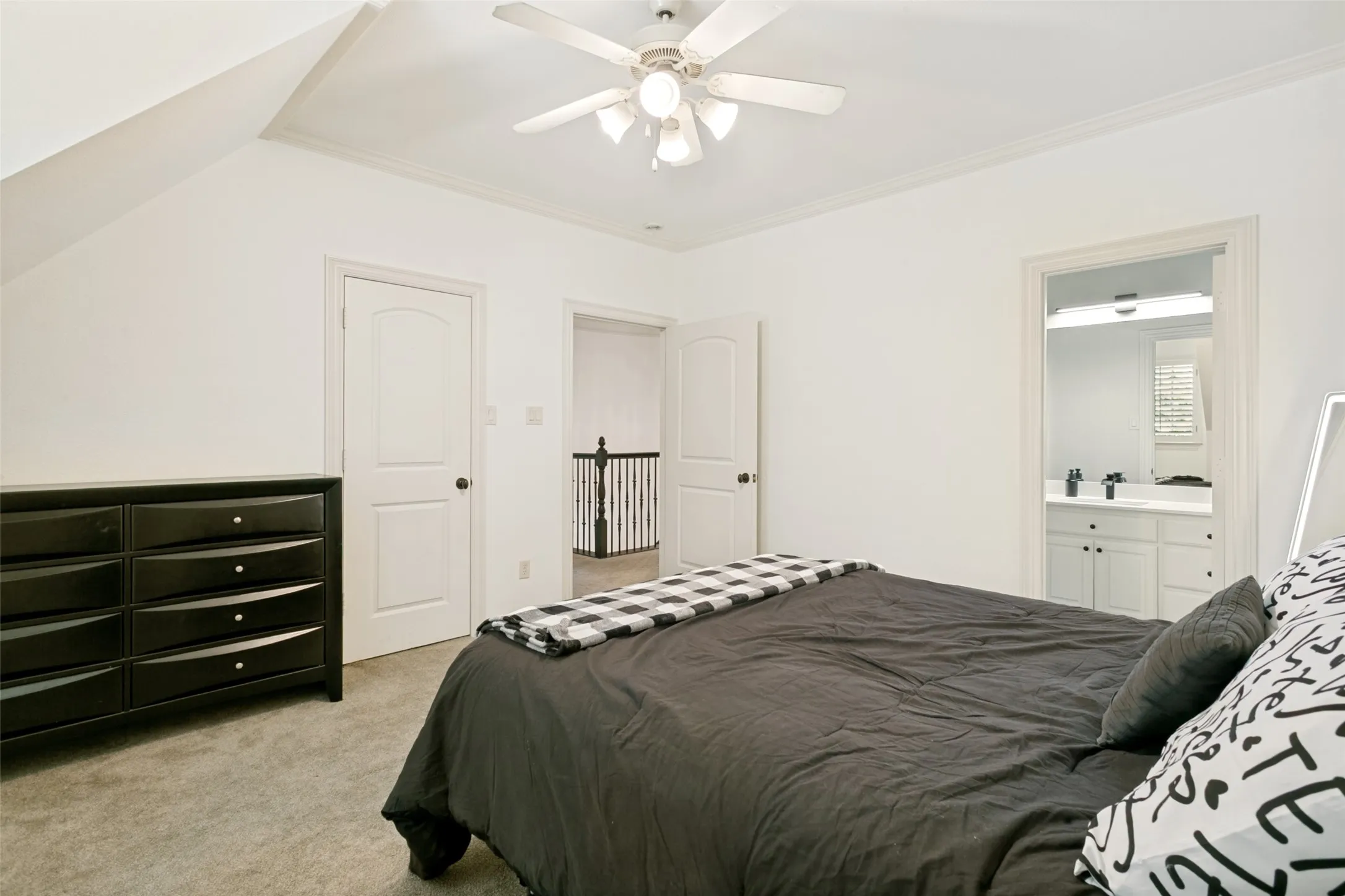 Bedroom featuring light gray carpet, white walls, and a ceiling fan with integrated lighting