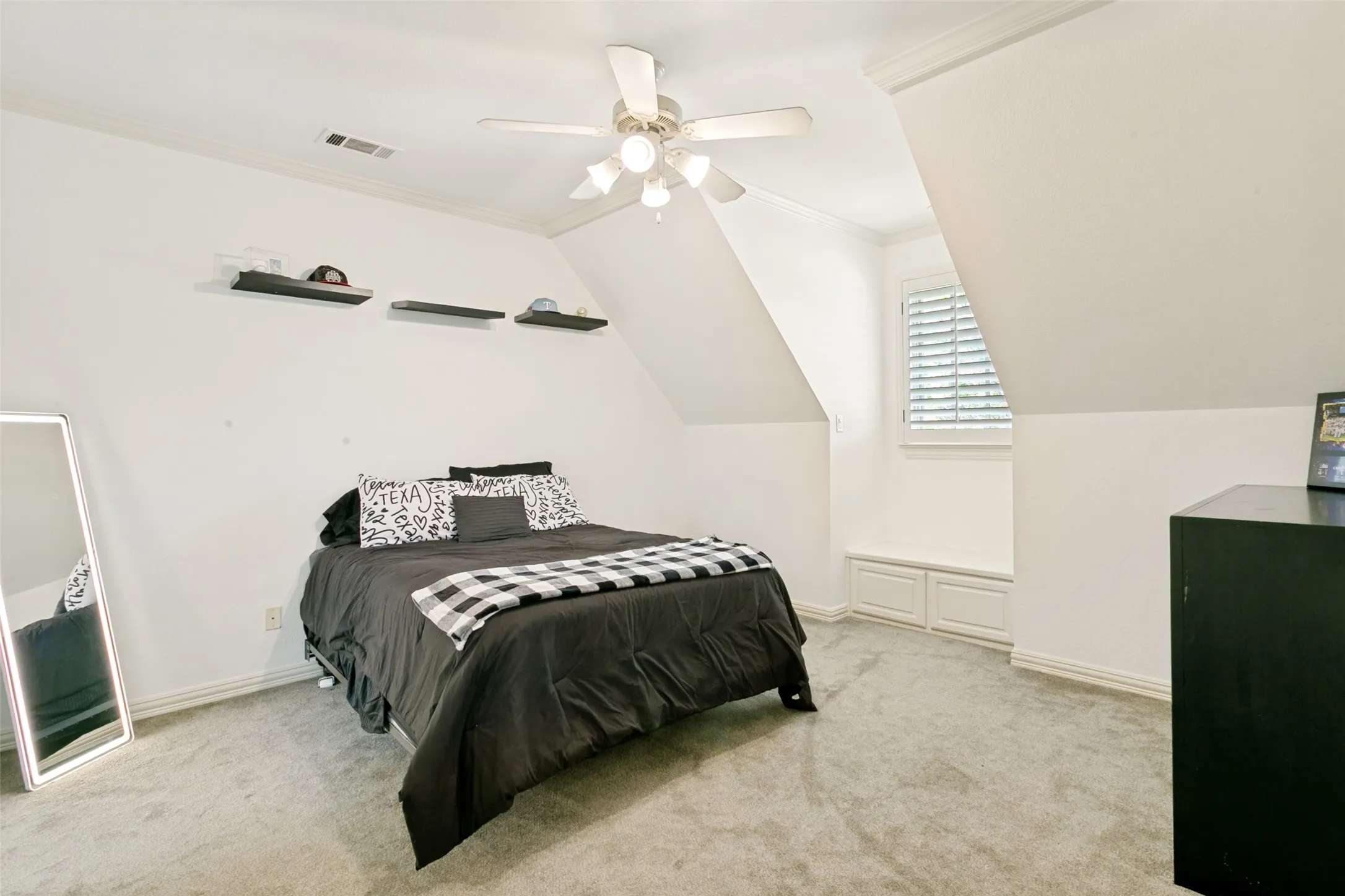 Dormer room featuring sloped ceilings, crown molding, and light gray carpeting