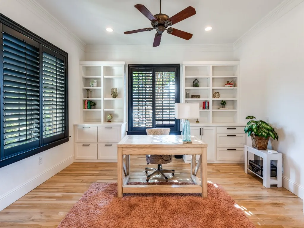 Updated office off the foyer with built-in cabinetry and plantation shutters.