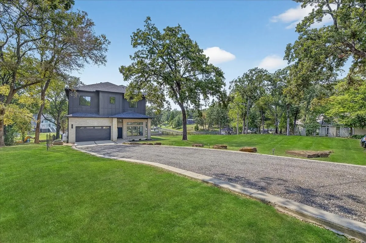 Spacious front lawn and oversized driveway enhance the property's curb appeal