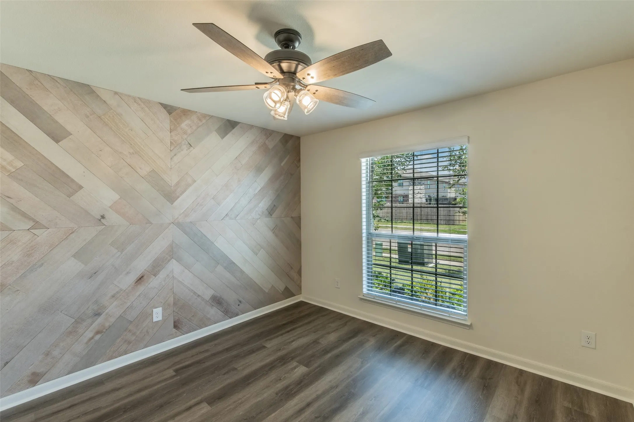 Bedroom 3 with accent wall featuring a herringbone wood-finish pattern