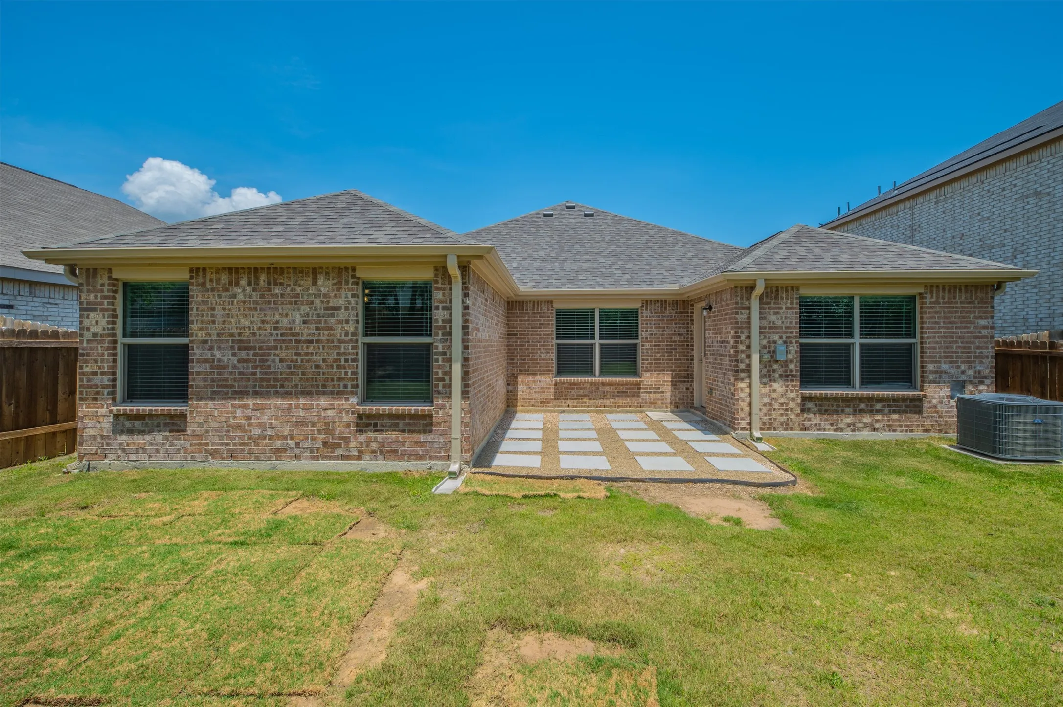 Brick exterior with a gabled roofline and light-colored gutters