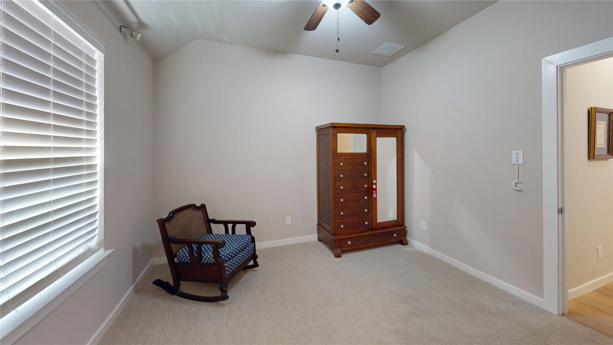 Carpeted room with a ceiling fan, a window featuring white horizontal blinds, and neutral painted walls