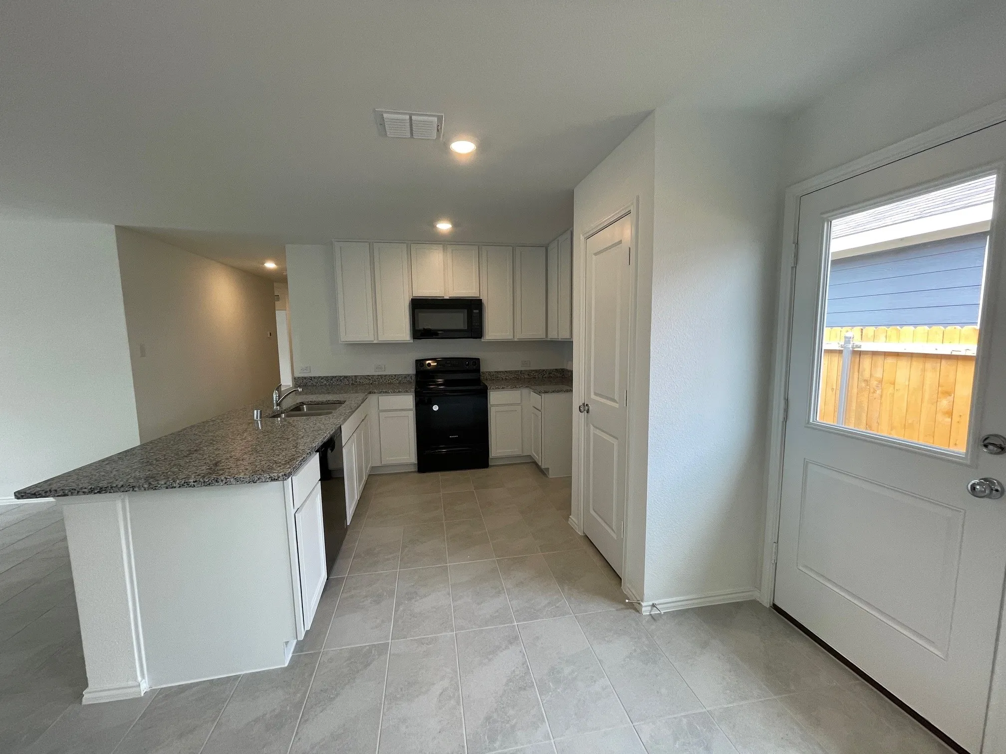 Kitchen with exterior side door and pantry