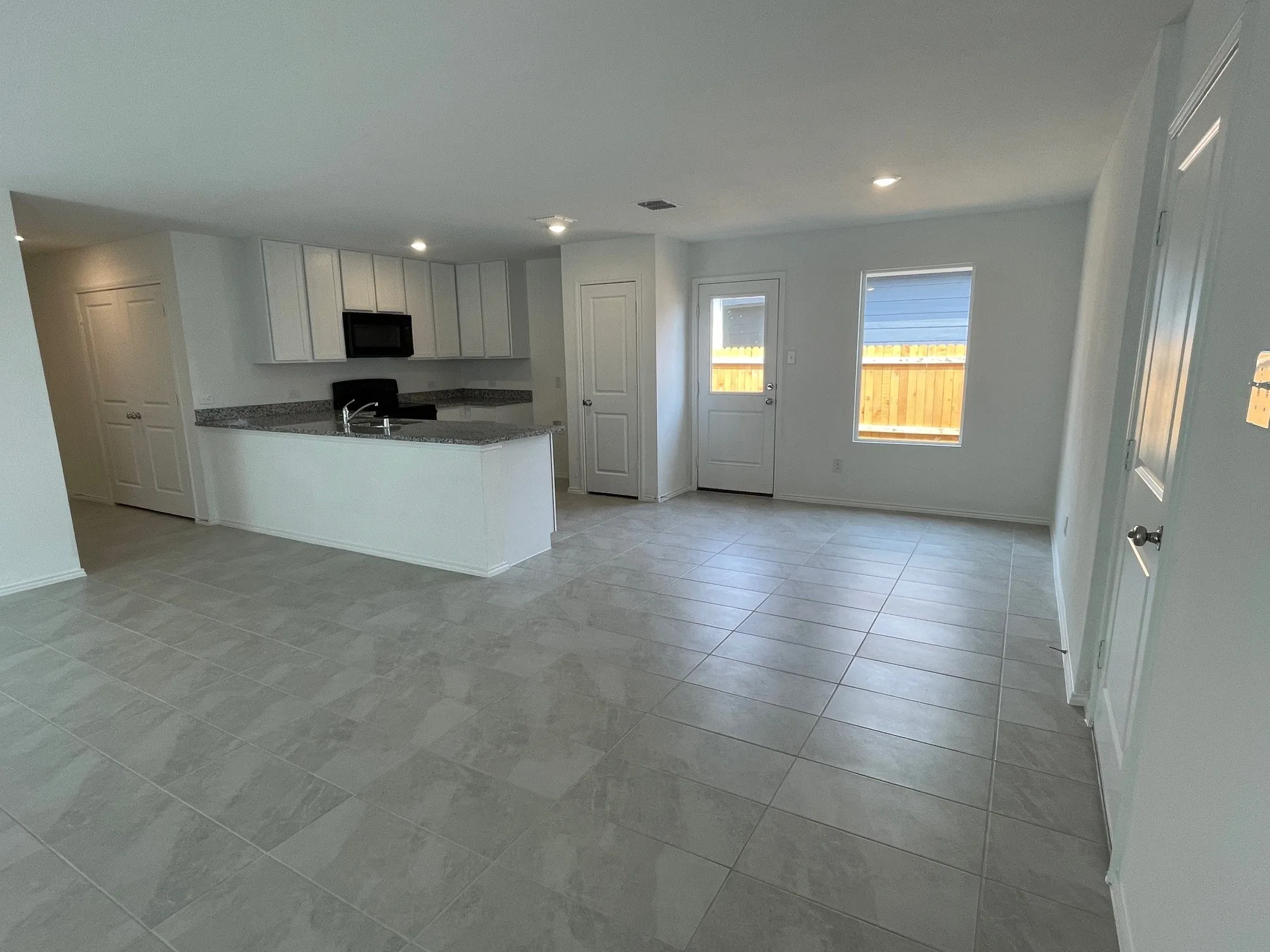 Entry door to right and family room to left with kitchen and breakfast room in the background
