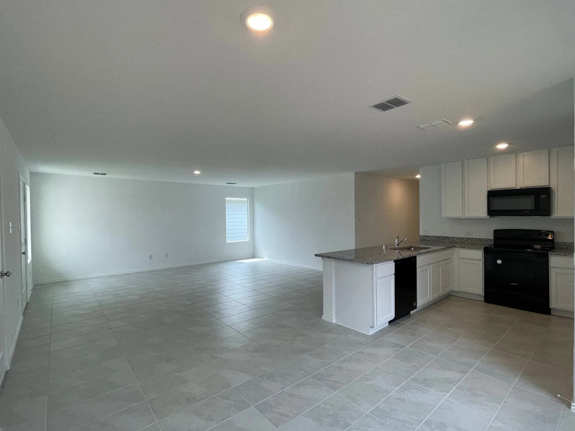 Standing in the breakfast nook looking at kitchen and family room in the background