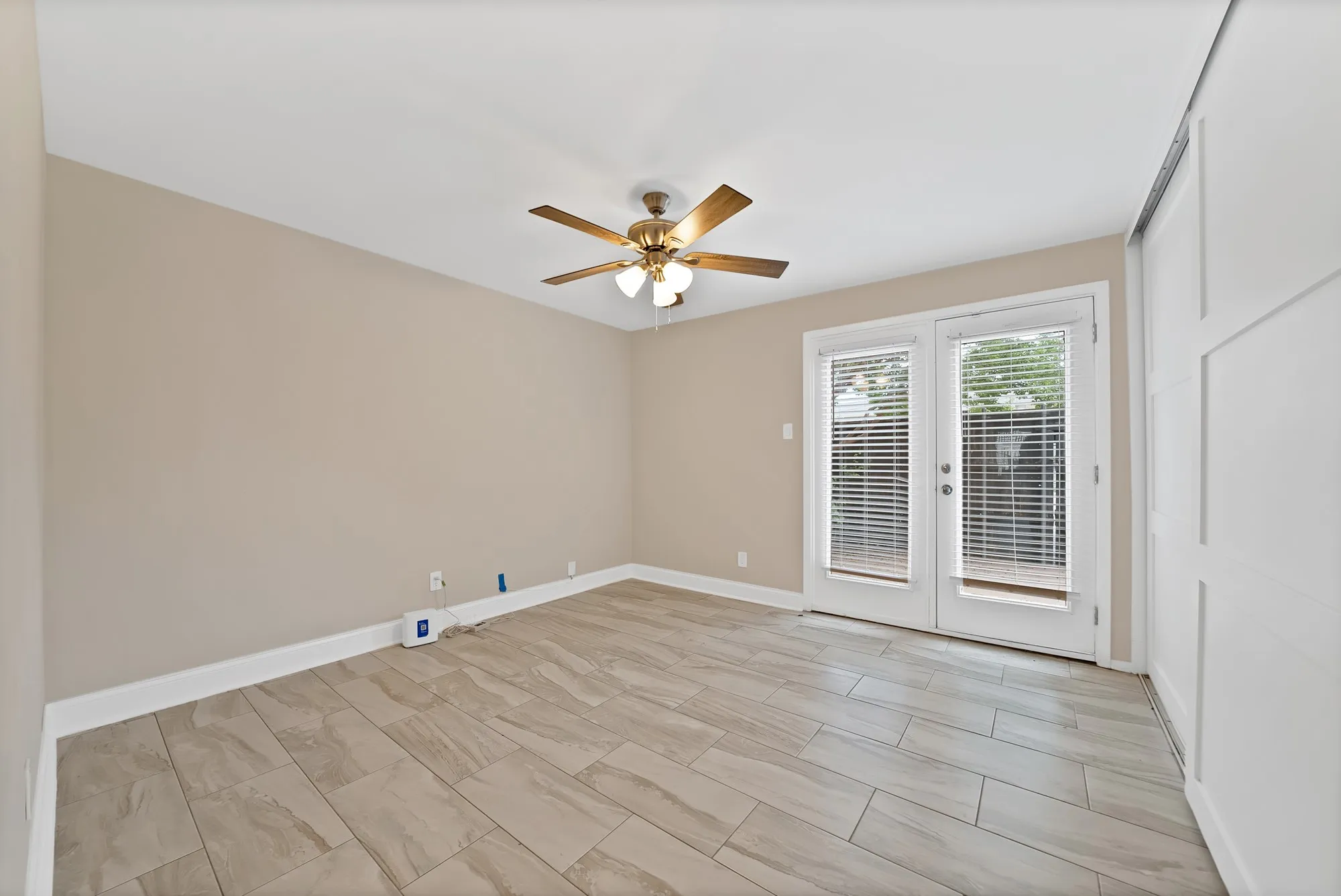 Bedroom 2 with doors to back deck