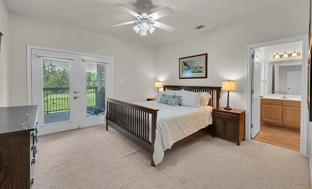Large master bedroom with entrance to back patio.