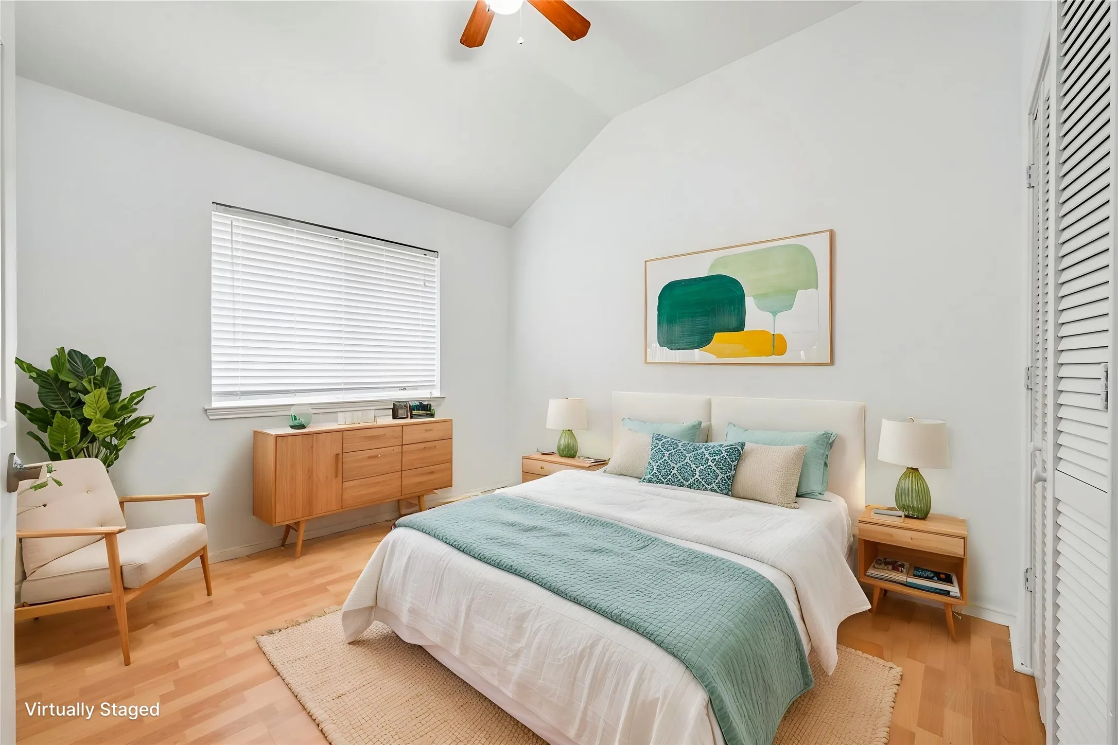 Vaulted ceiling with a ceiling fan, light wood-finish flooring, a window with blinds, and white louvered closet doors