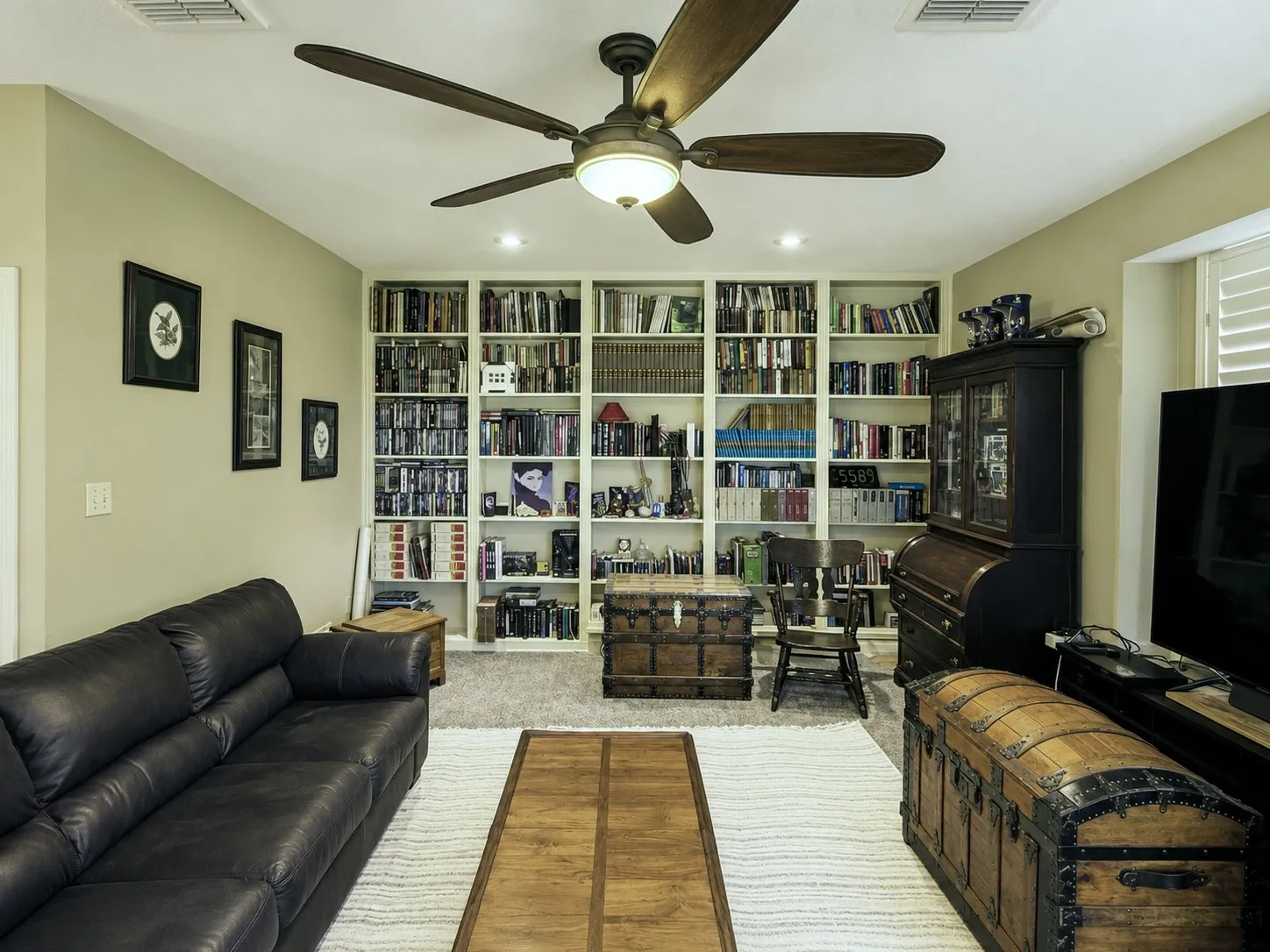 The den has plantation covered windows on two walls, one even faces the backyard and floods this end of the house with natural light, Esau wall of built-in shelving and a stately brick hard woodburning fireplace.