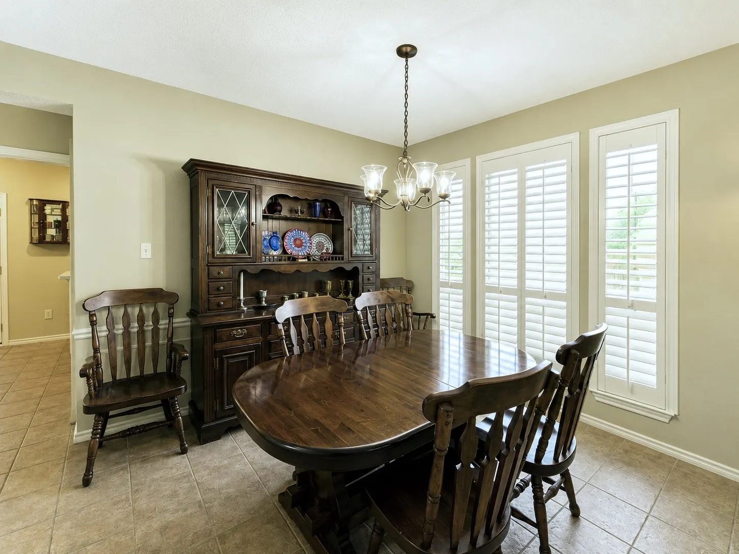 Another dining room with large windows covered with plantation shutters viewing Wilson Creek Park from across the boulevard.