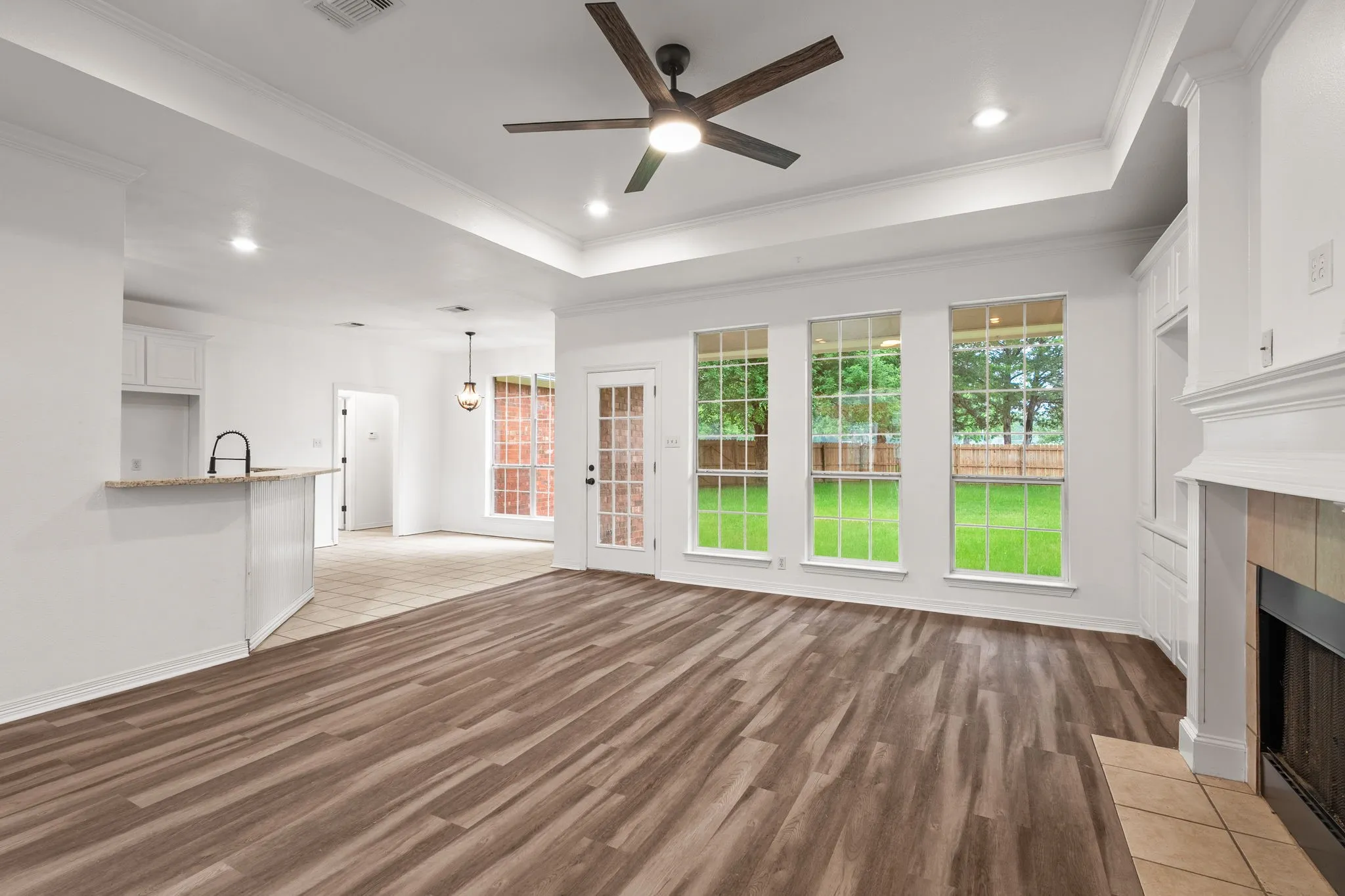 large living room gas log fireplace and kitchen bar