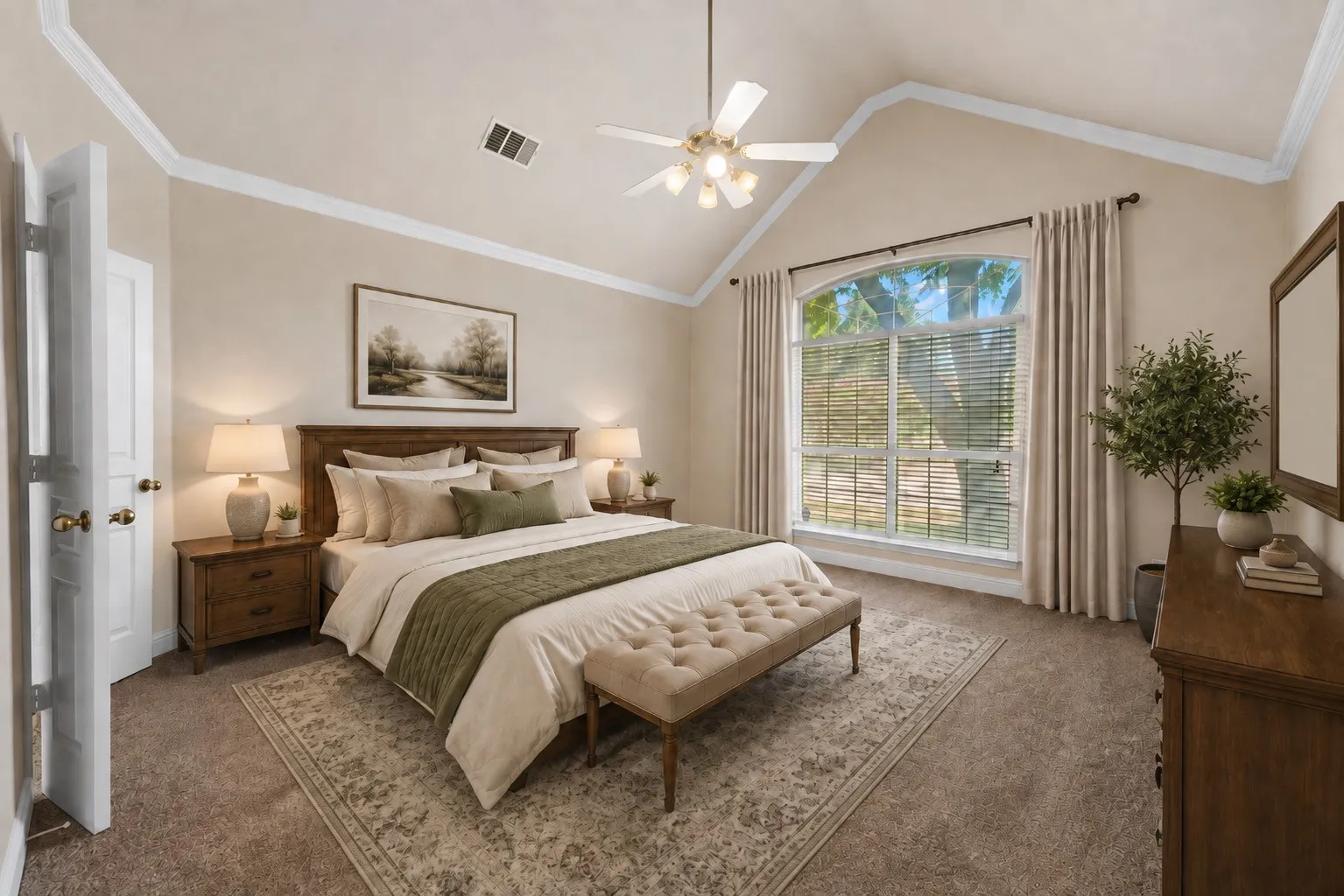 Virtual Stage..Vaulted ceiling with crown molding, ceiling fan with light fixture, arched window with window treatments, wood-finish headboard, and coordinating wood-finish nightstands