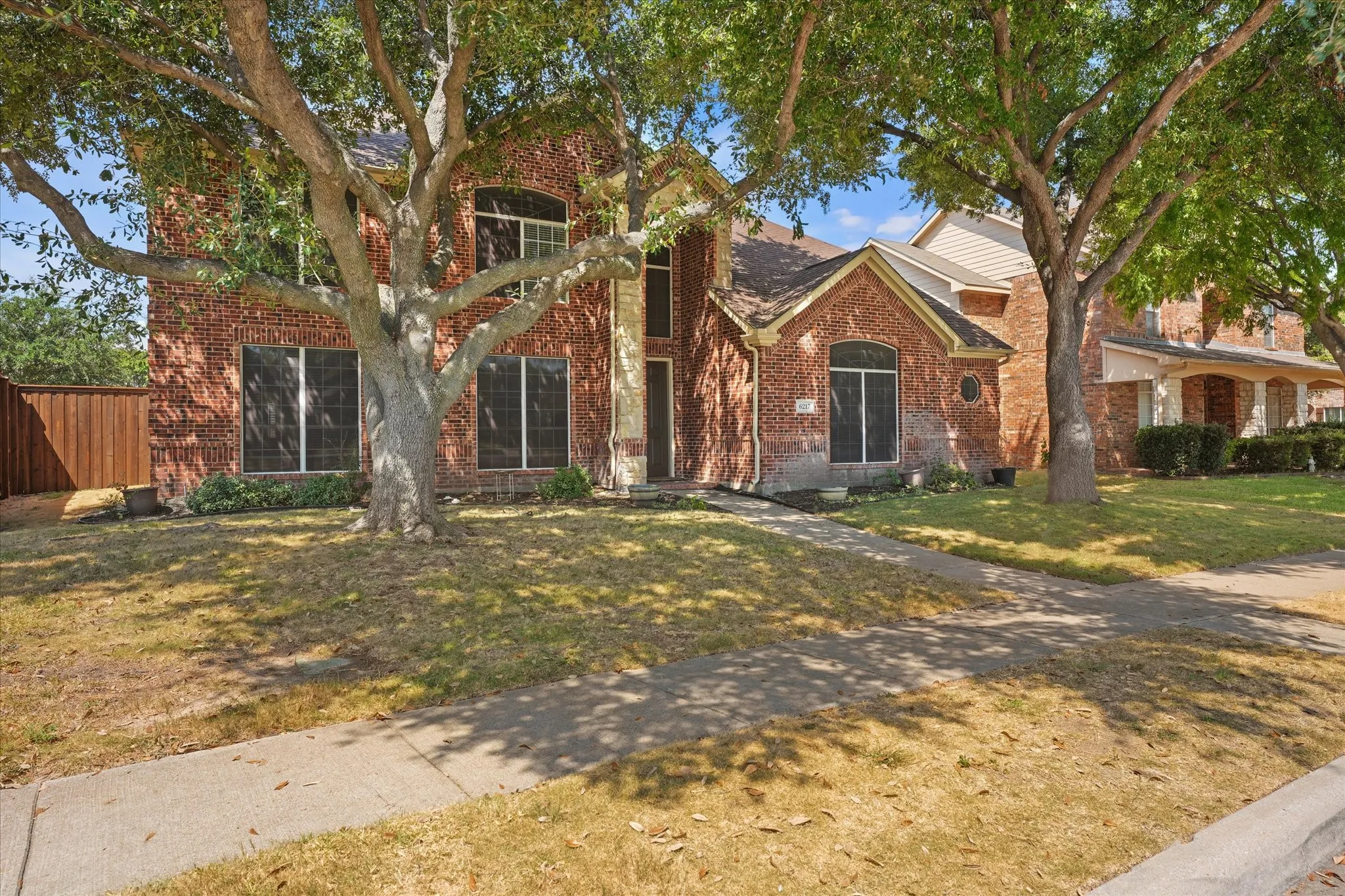 Traditional brick exterior with an arched entry and stone accents