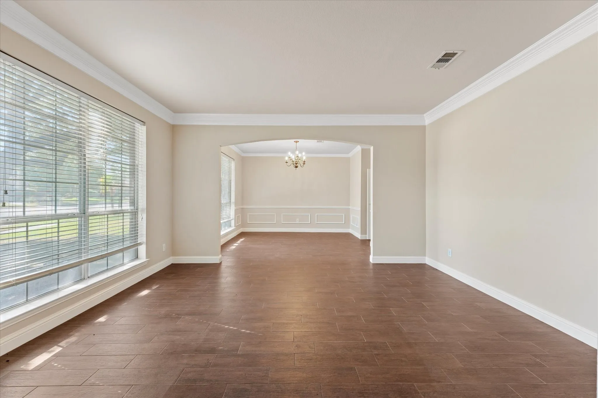 Front family room and Dining room. Spacious room with wood-finish flooring and crown molding