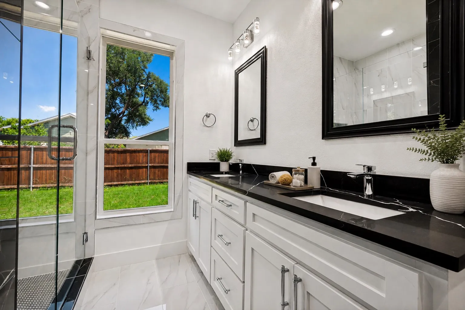 Dual sinks frameless shower glass, granite counter tops