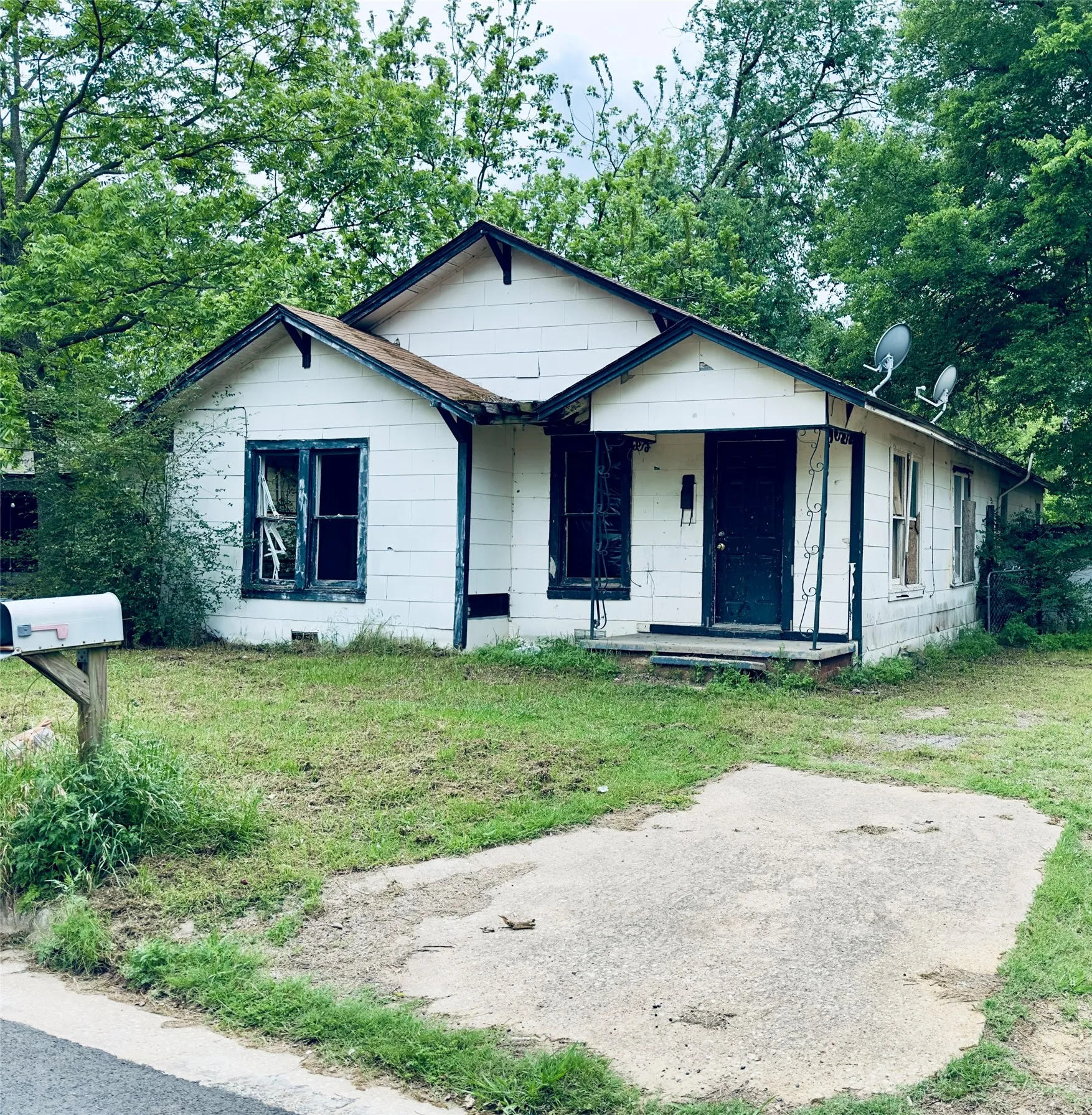 Single-story residence featuring white siding and a covered front porch