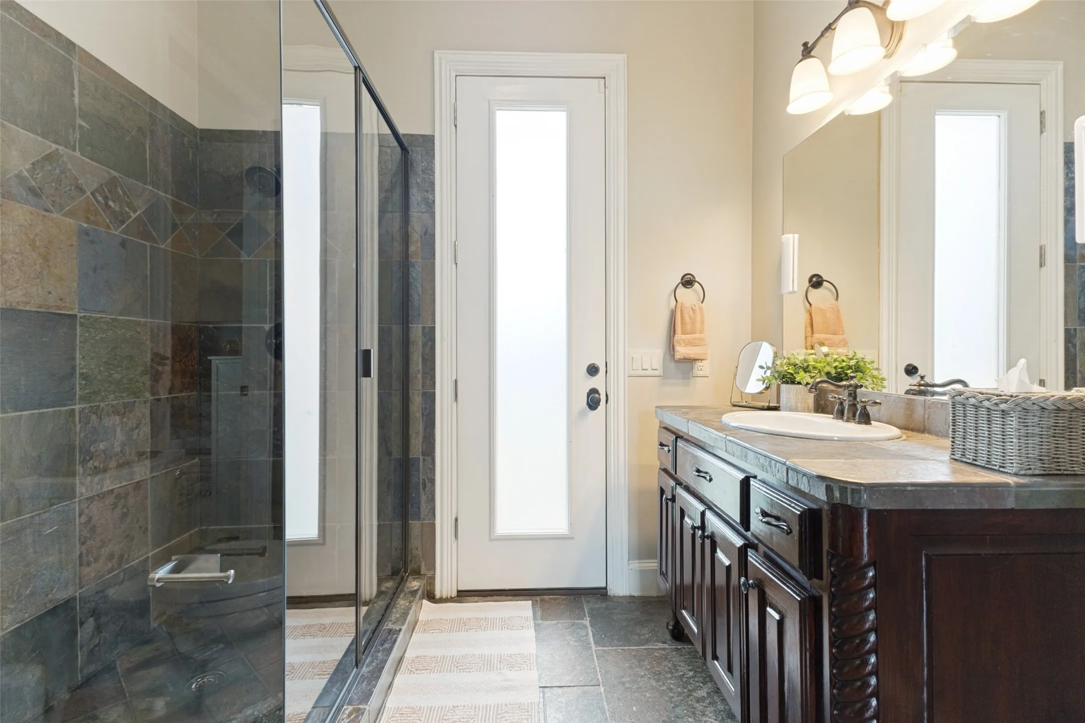 Downstairs bath with access to both the guest suite and the outdoor pool area.