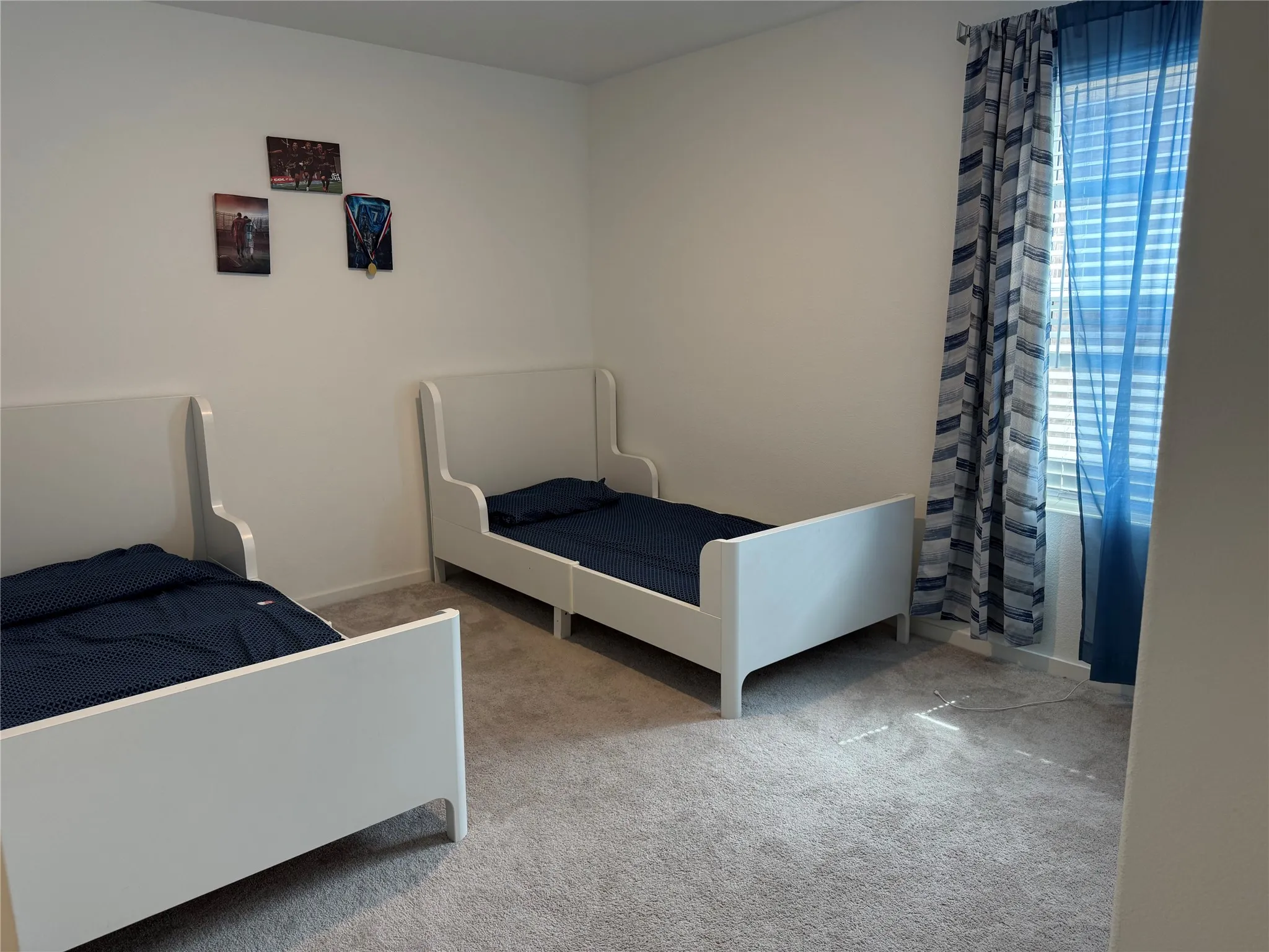 Room with light gray carpet flooring and white painted walls