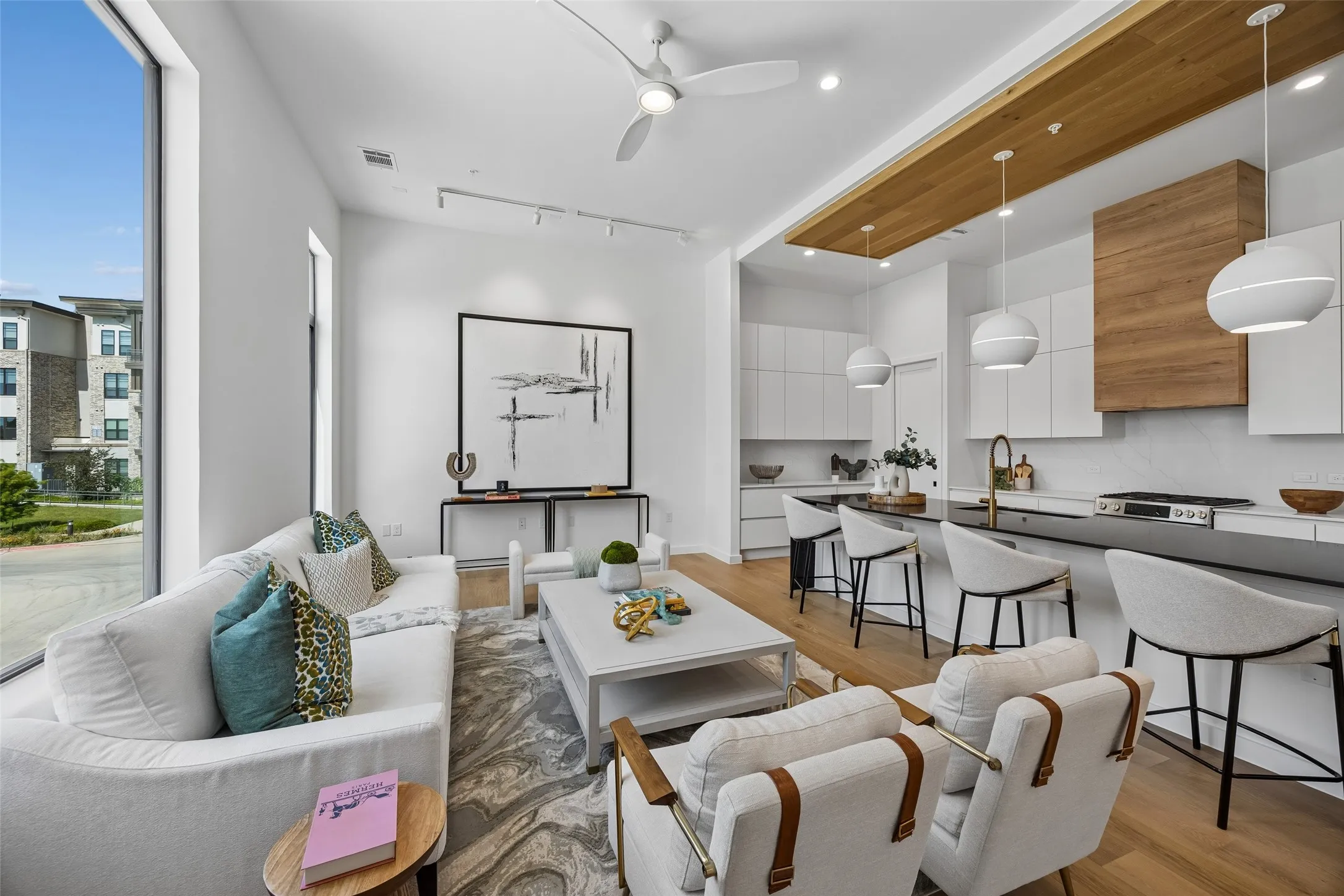 Open-concept living space with wood-finishes on cabinetry and ceiling.