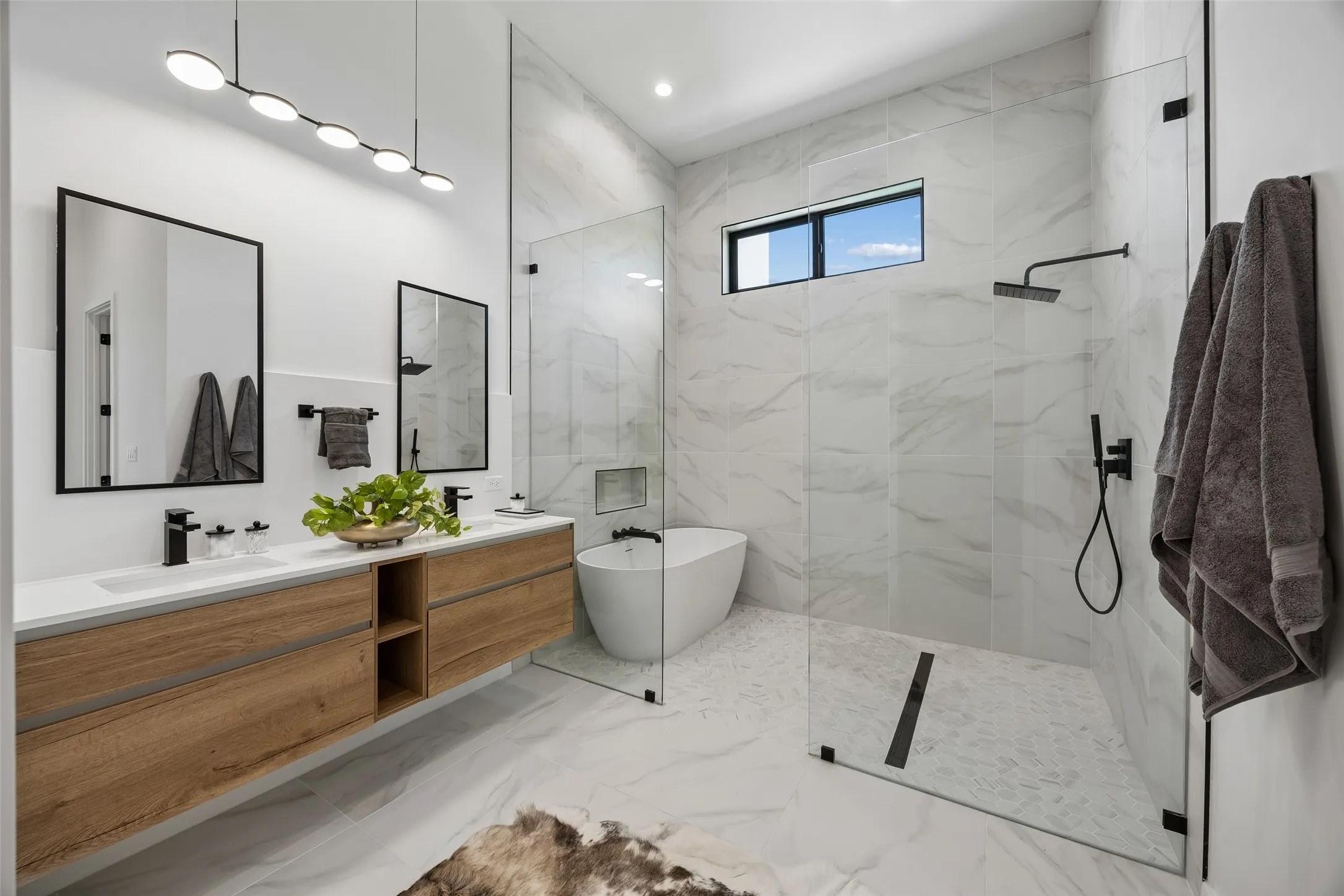 A deep soaking tub and rain shower evoke a spa setting.