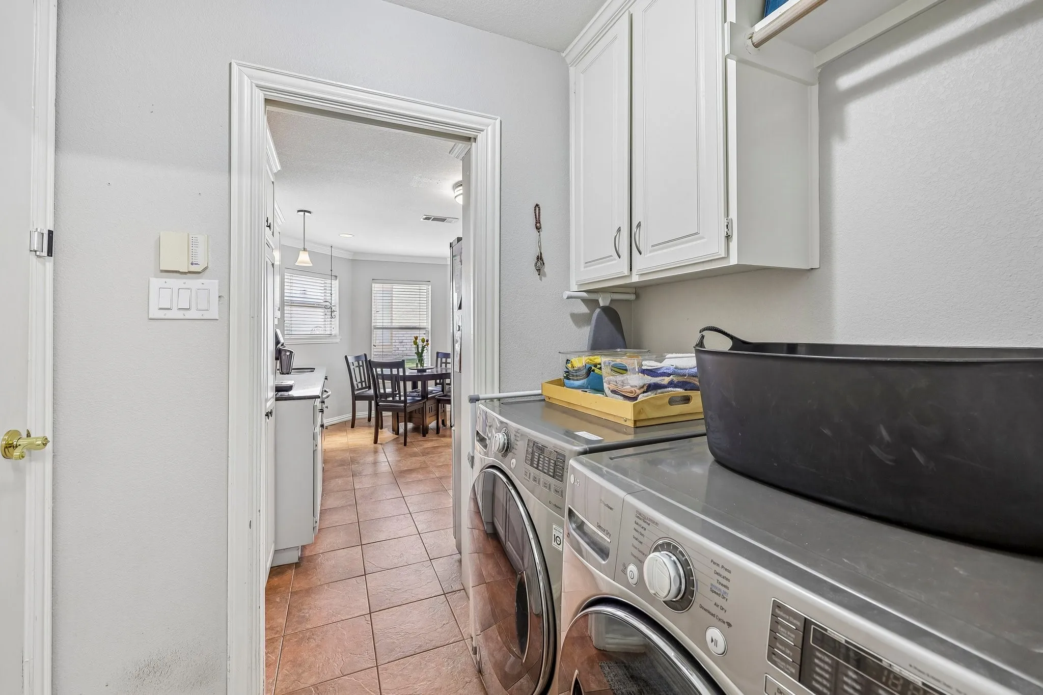 Laundry room connects to the primary walk-in closet and to the kitchen..so convenient
