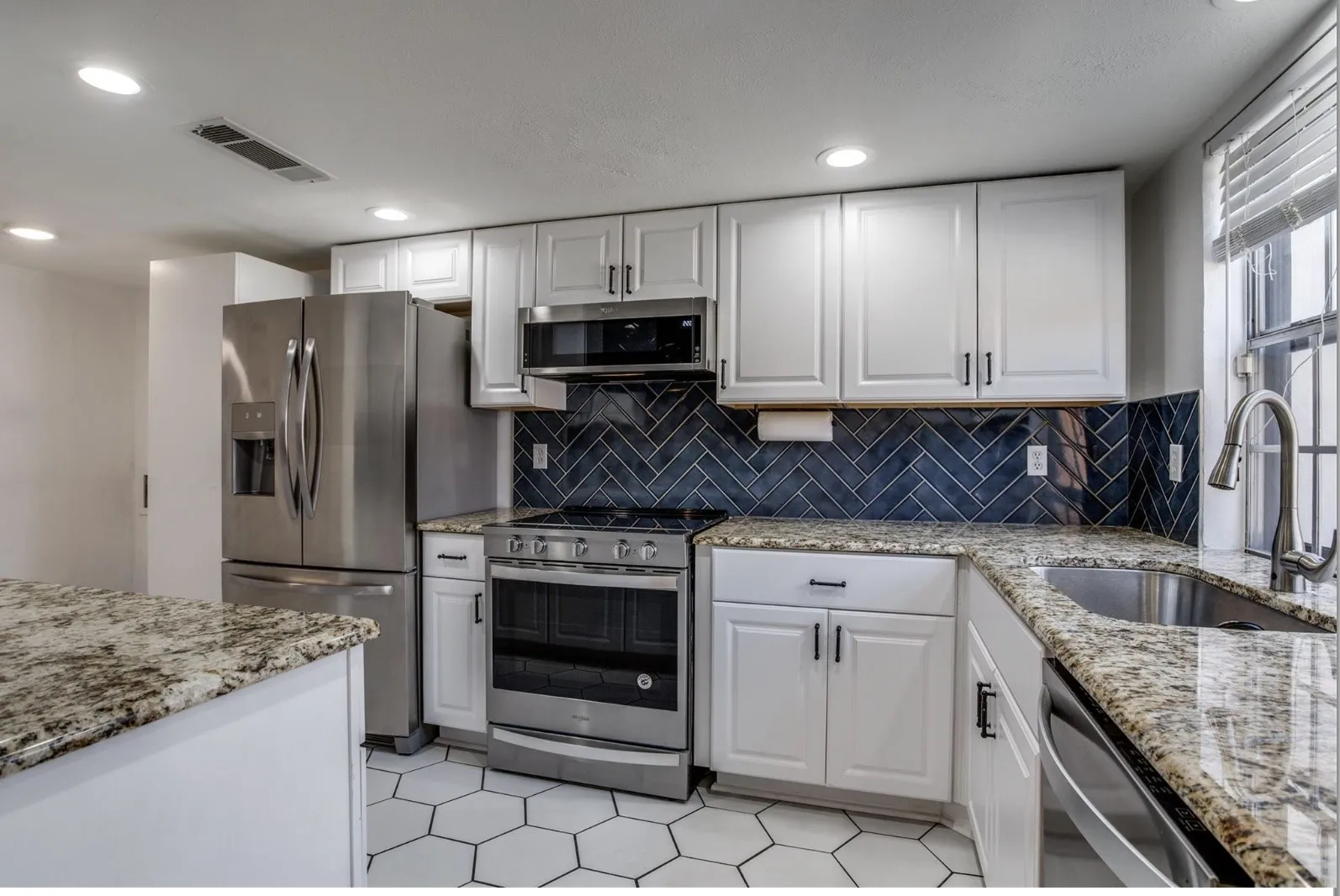Granite, Lots of cabinet storage space, stainless steel appliances, refrigerator, washer, and dryer all convey!