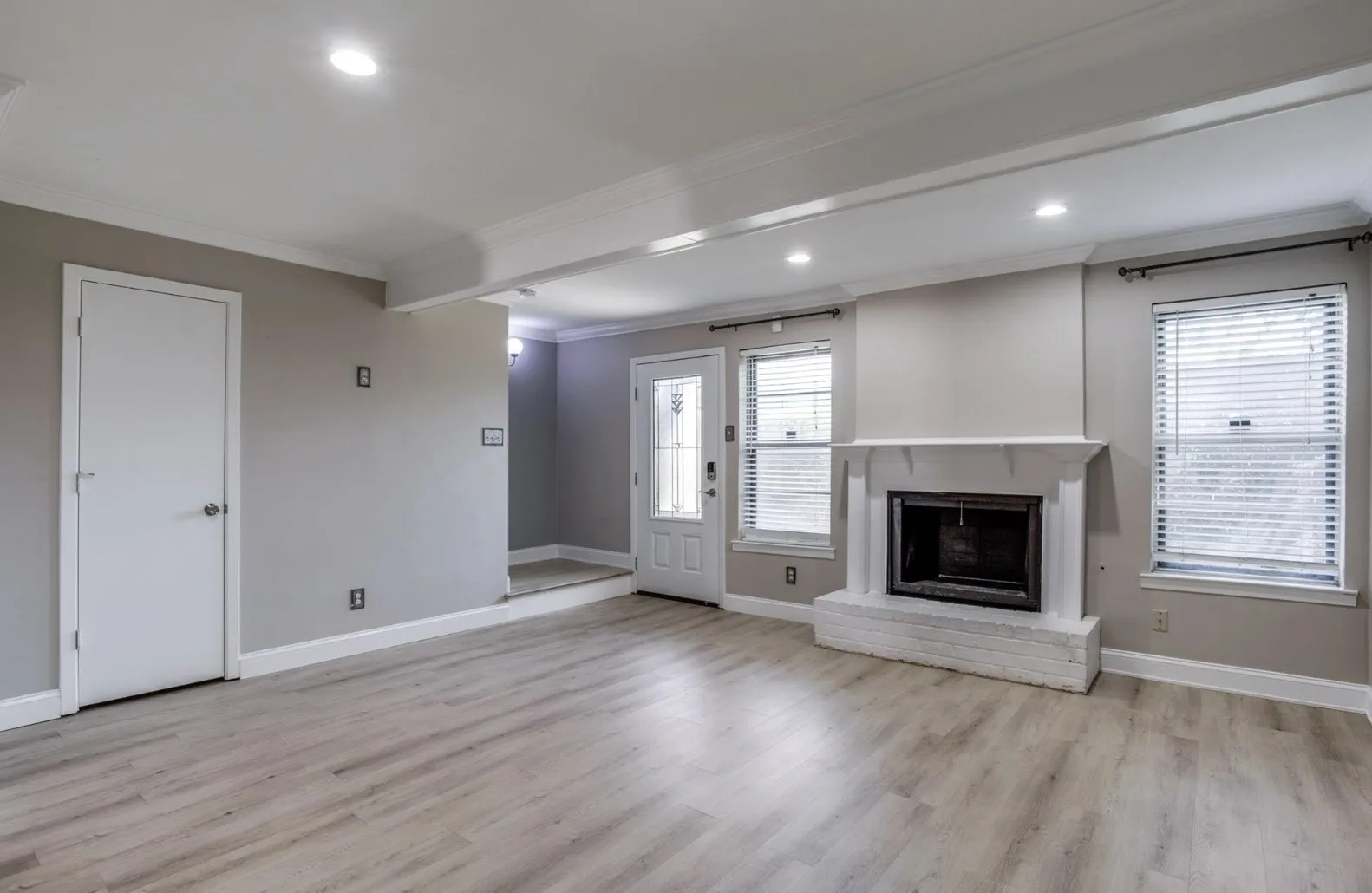 Fireplace, abundant natural light, under-stairway closet, stairway to bedrooms, and beautiful front door.