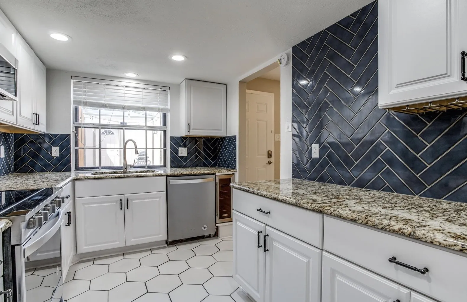 Bright, cheerful kitchen with a large stainless steel sink. Window view and access to your private courtyard.