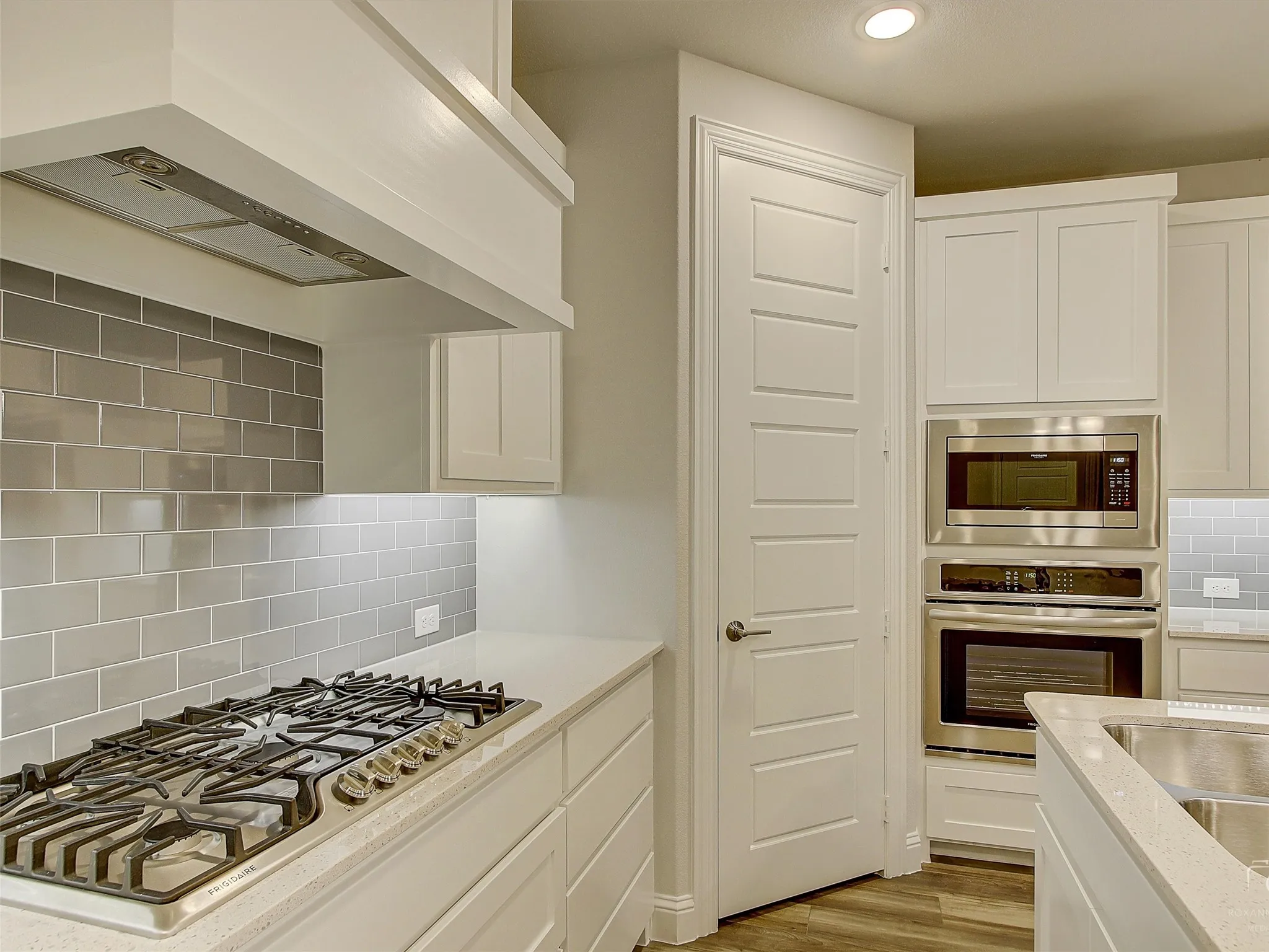 Kitchen featuring a gas cooktop, built-in stainless steel microwave, and wall oven