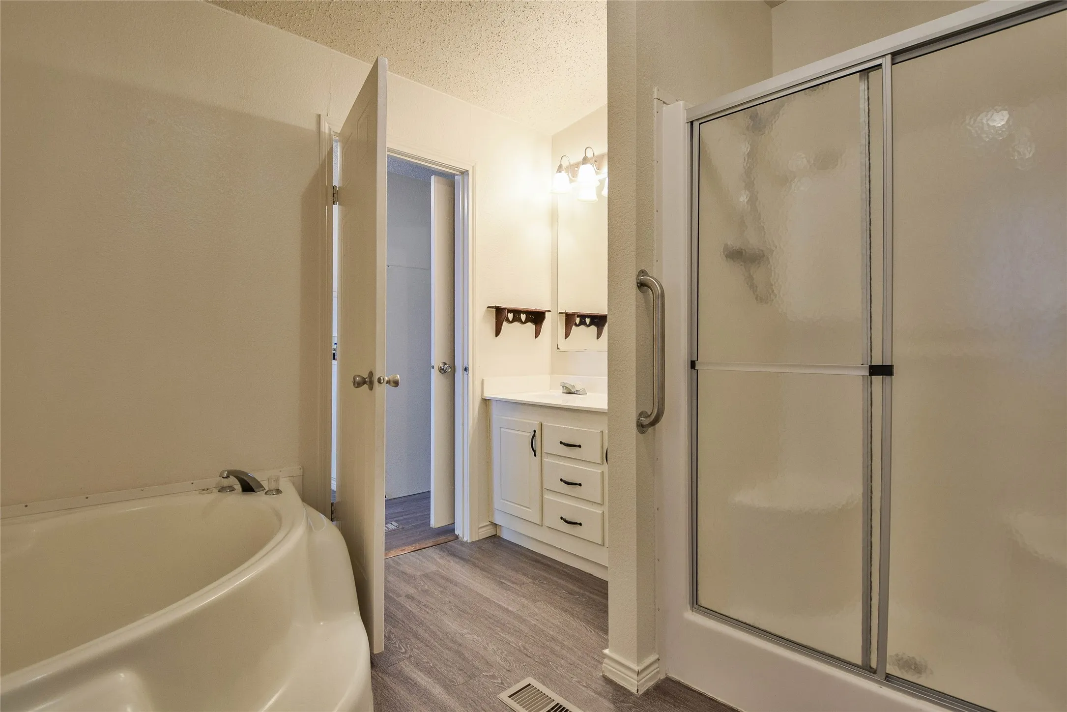 Spackous primary bathroom with great garden tub and separate shower.