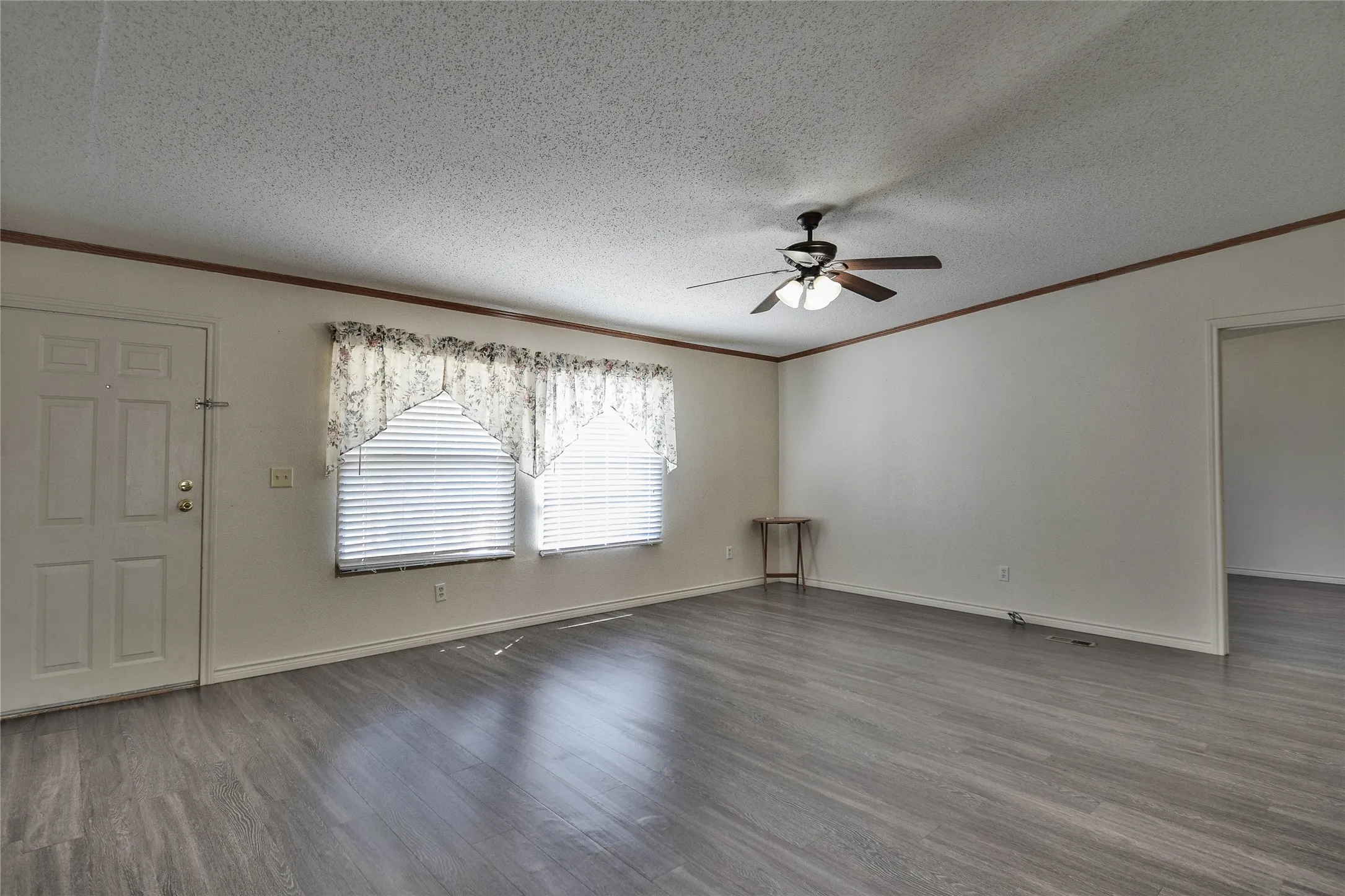 Large living room with great windows and vinyl wood-like flooring for easy care.