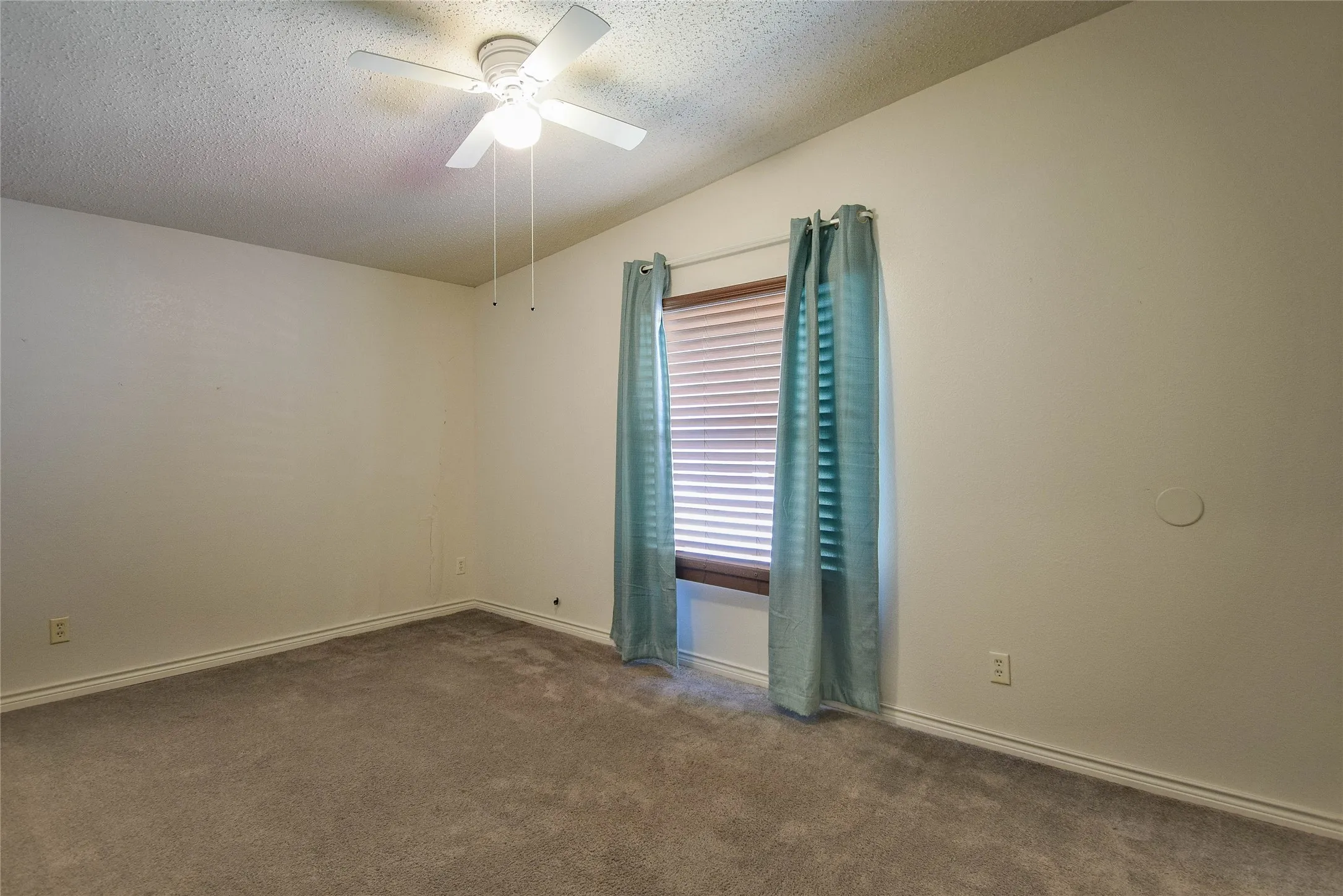 Guest bedroom with ceiling fan and great natural lighting.