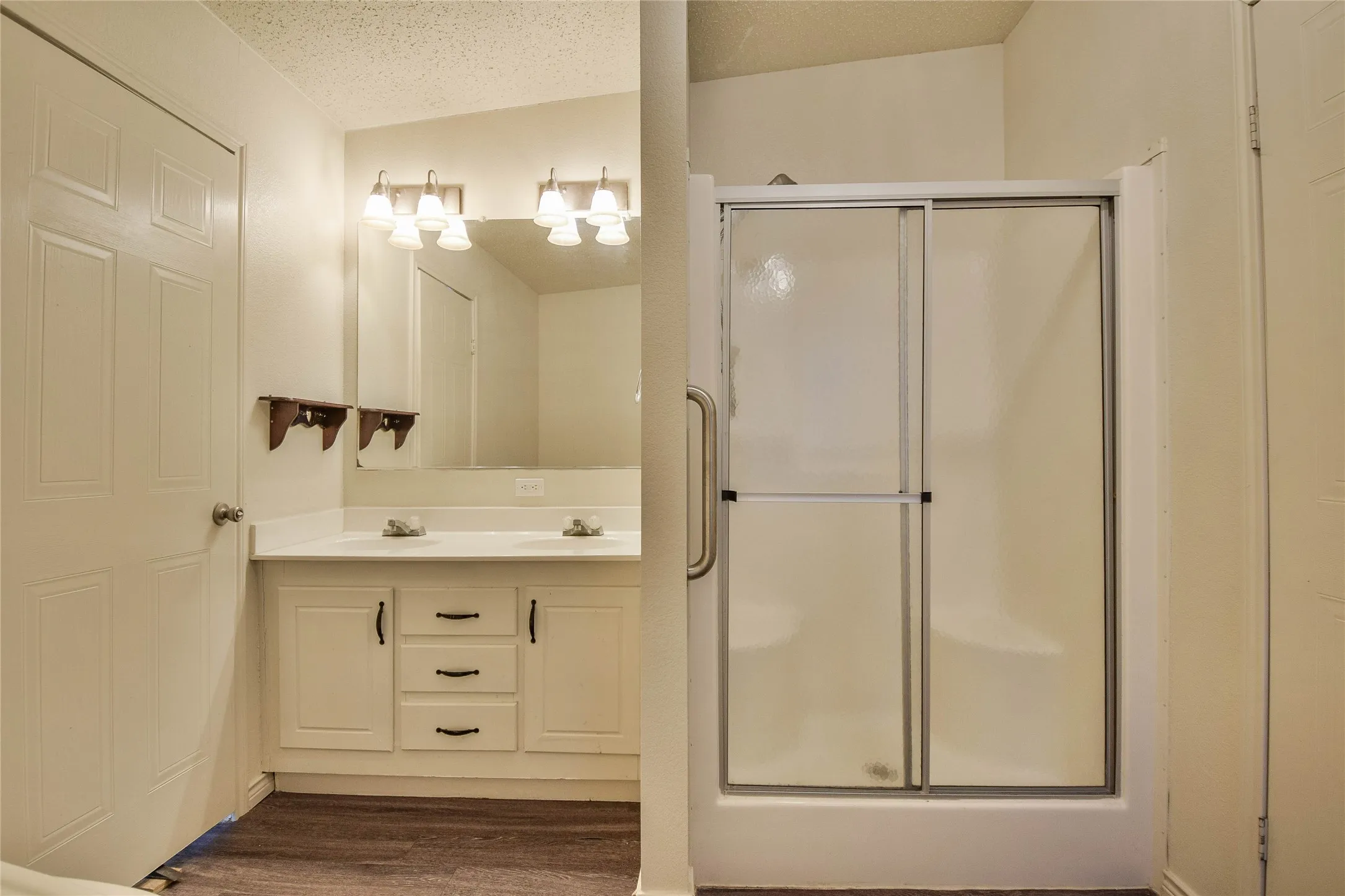 Beautiful primary bath with dual sinks, great lighting and built-in cabinet
