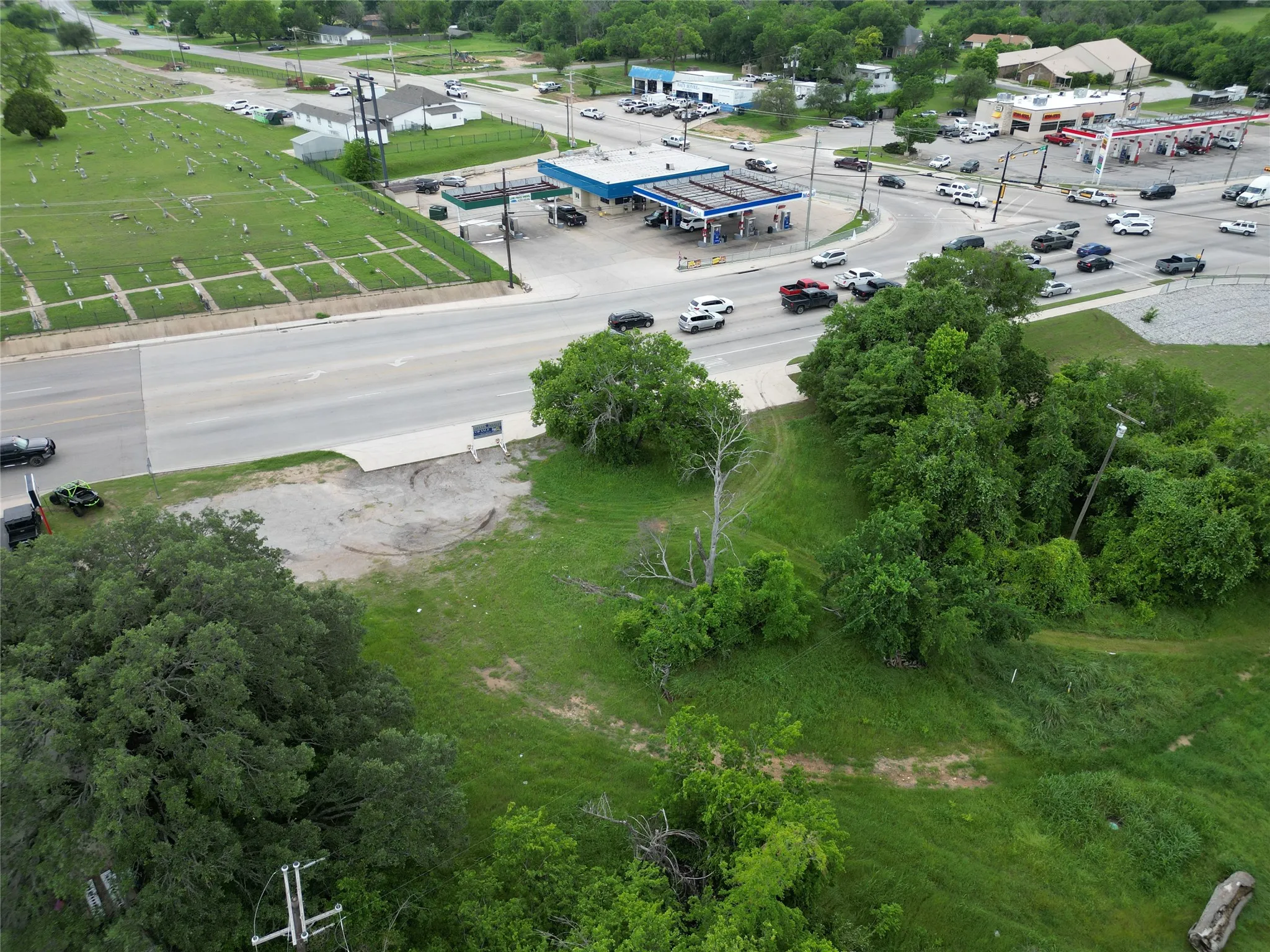 Expansive land parcel featuring existing greenery and level ground