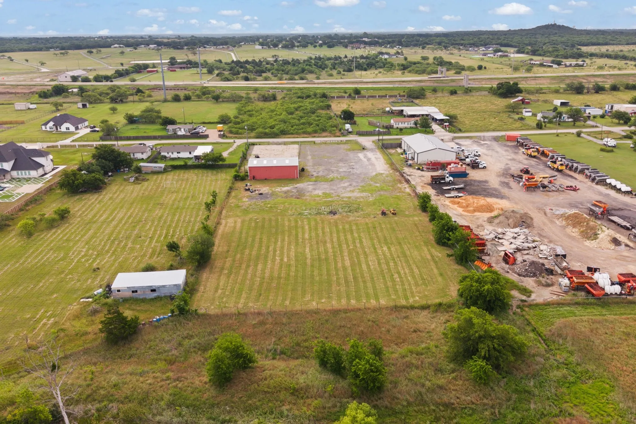 Expansive property featuring multiple structures and open land