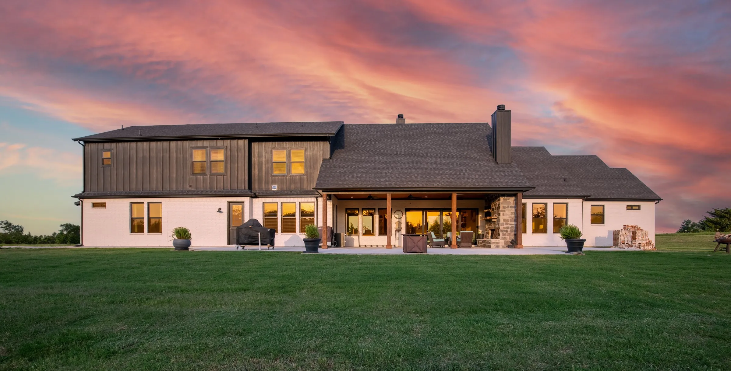 Large backyard with ample space for additional structures, pool, volleyball or recreation court. Includes a covered patio with exposed wood beams, a stone-clad fireplace, and is plumbed for outdoor kitchen.