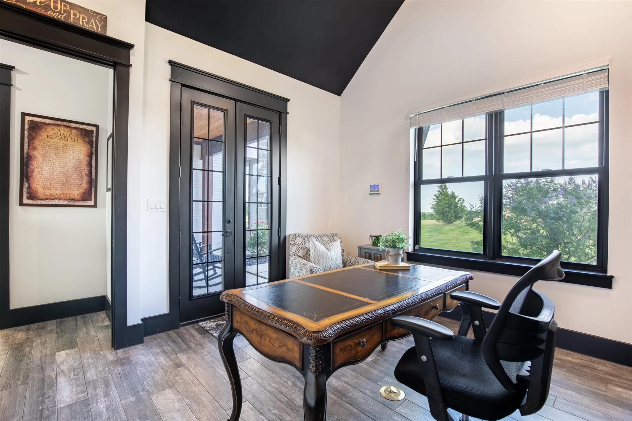 Private office with vaulted ceilings overlooking front yard. Include French doors leading to private patio area.