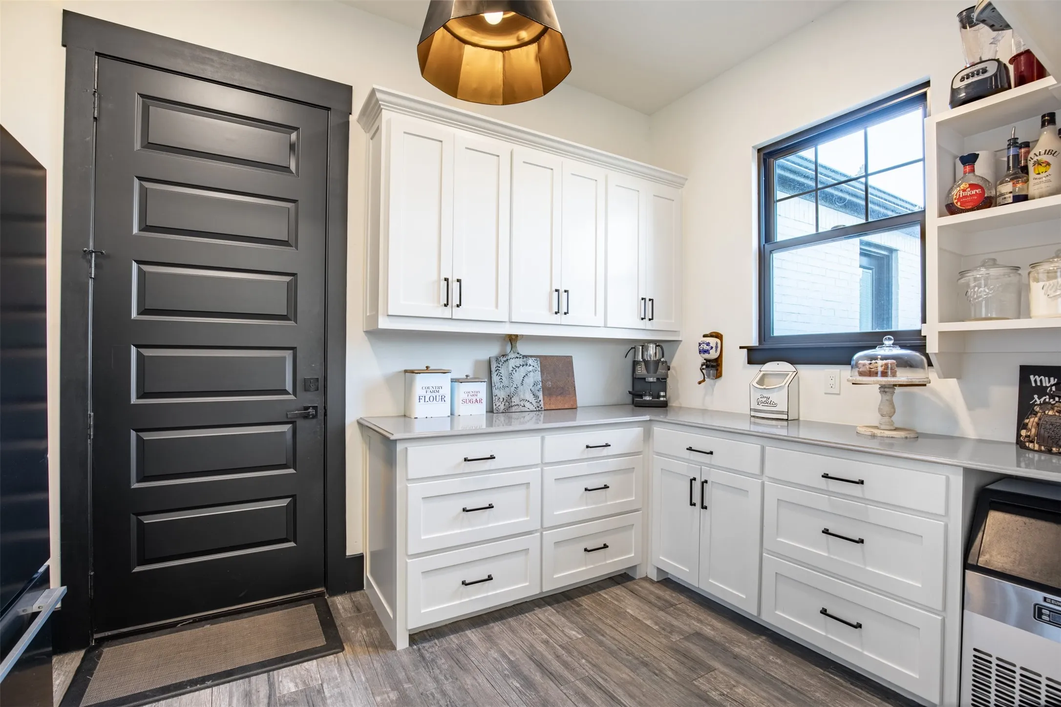 Full size walk in prep pantry with ample storage, ice maker and fridge. Connects to garage and kitchen areas