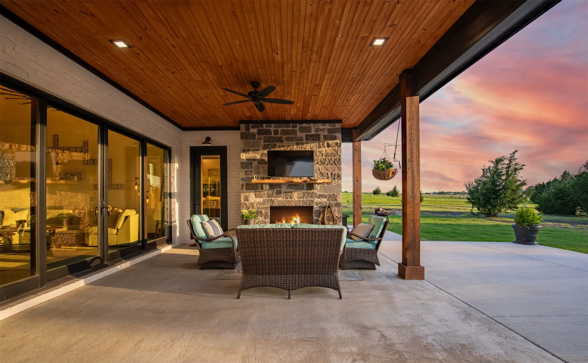 Expansive covered patio off the rear of the home with wood burning fireplace. Interior doors include access to primary suite on one side and breakfast nook on the other side. Ample views of beautiful open space and Texas sunsets.
