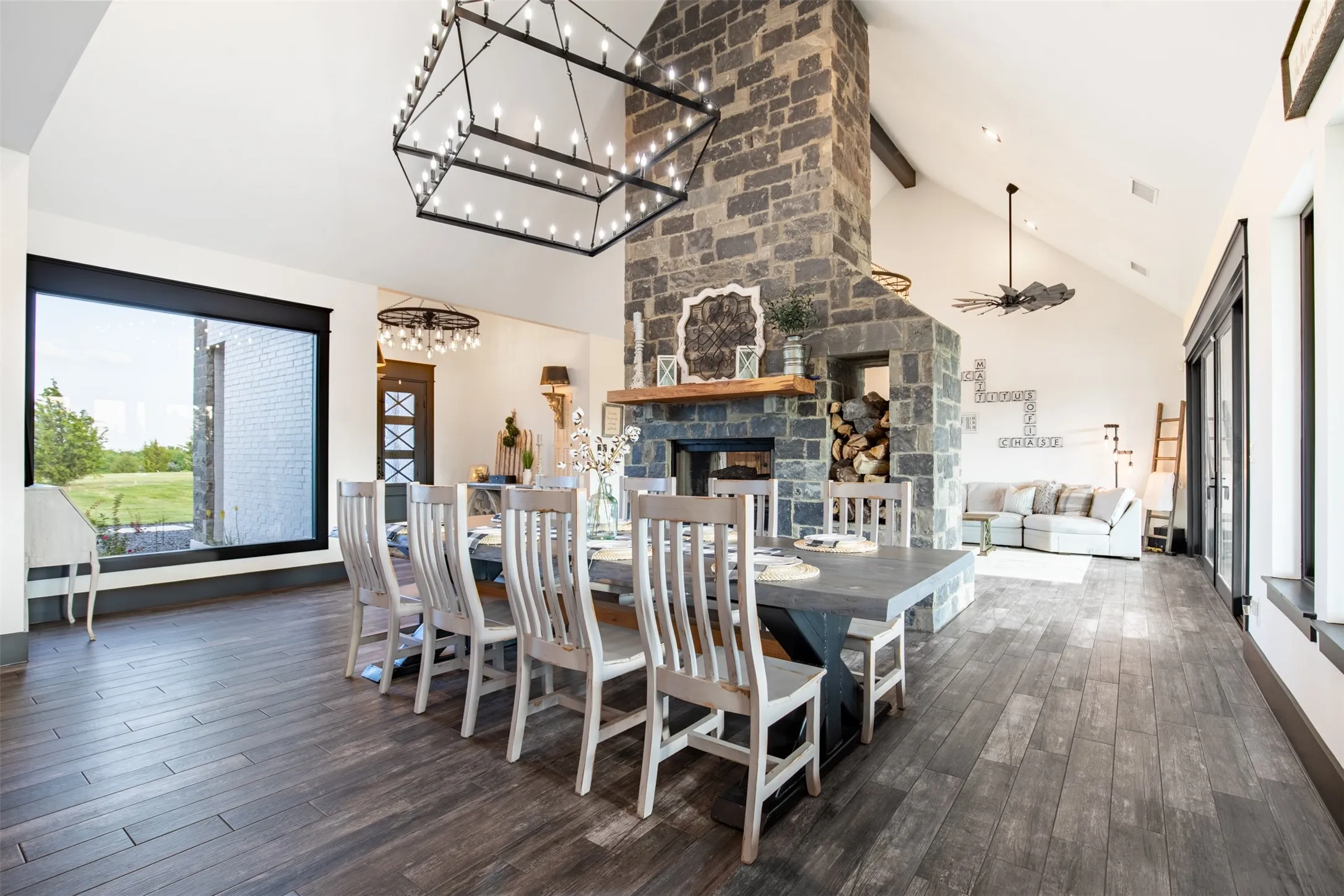 Open concept dining area overlooks large picture window to the front and covered patio to the sea of the home.