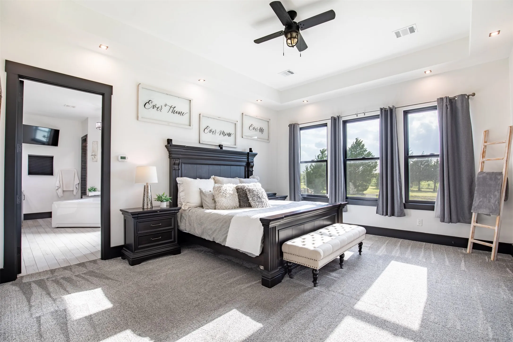 Spacious and private primary suite includes tray ceiling, built-in coffee bar and ensuite bathroom, plus very spacious and customized walk-in-closet