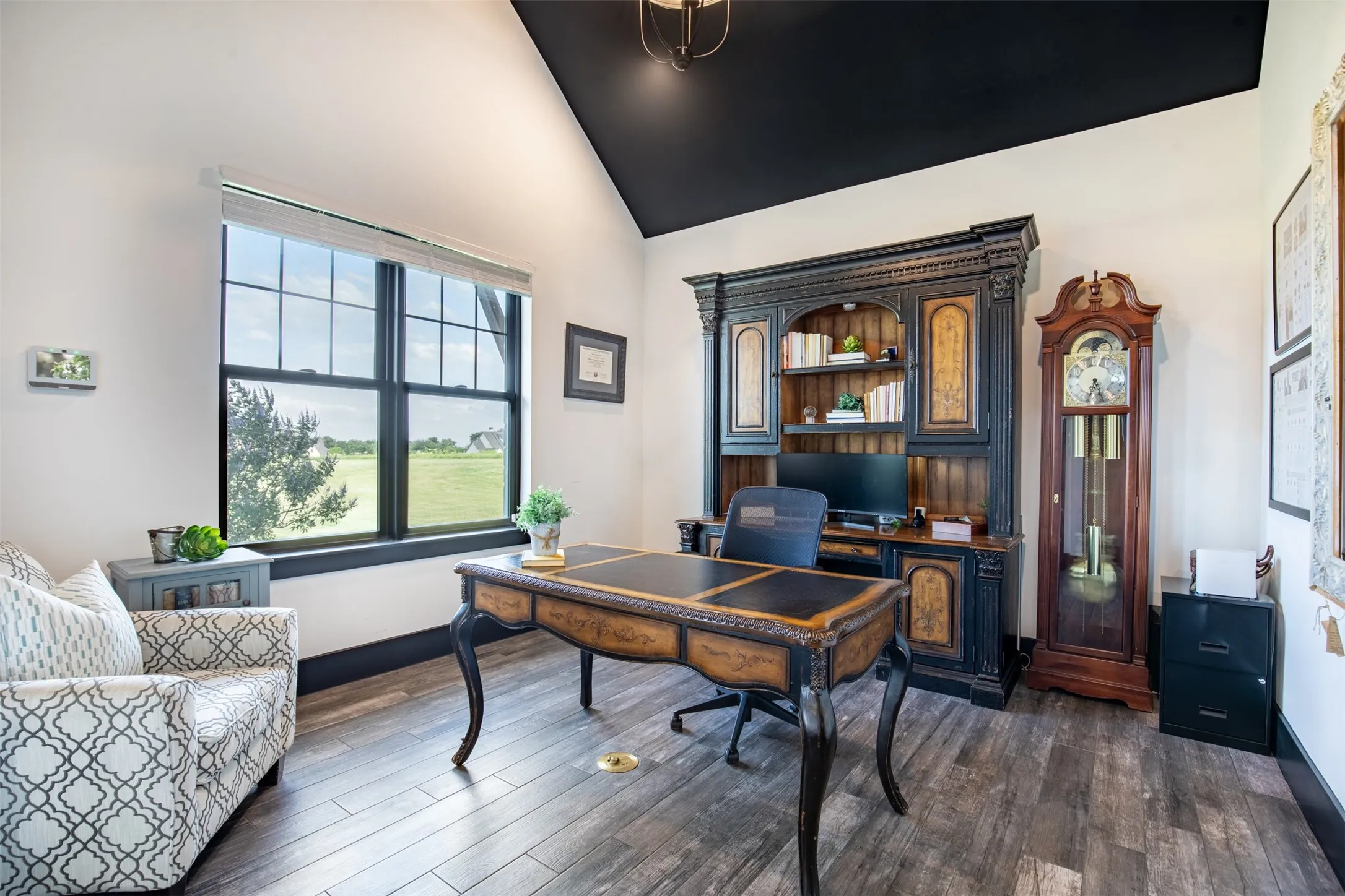 Downstairs office with vaulted ceilings and French doors leading to private patio off the front of the home