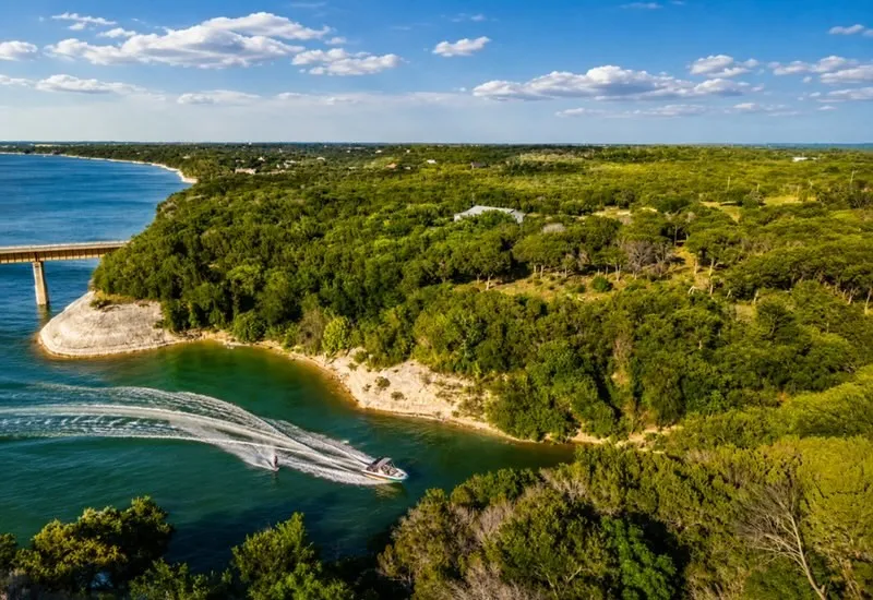 Expansive waterfront property featuring dense, mature tree coverage along a tranquil cove