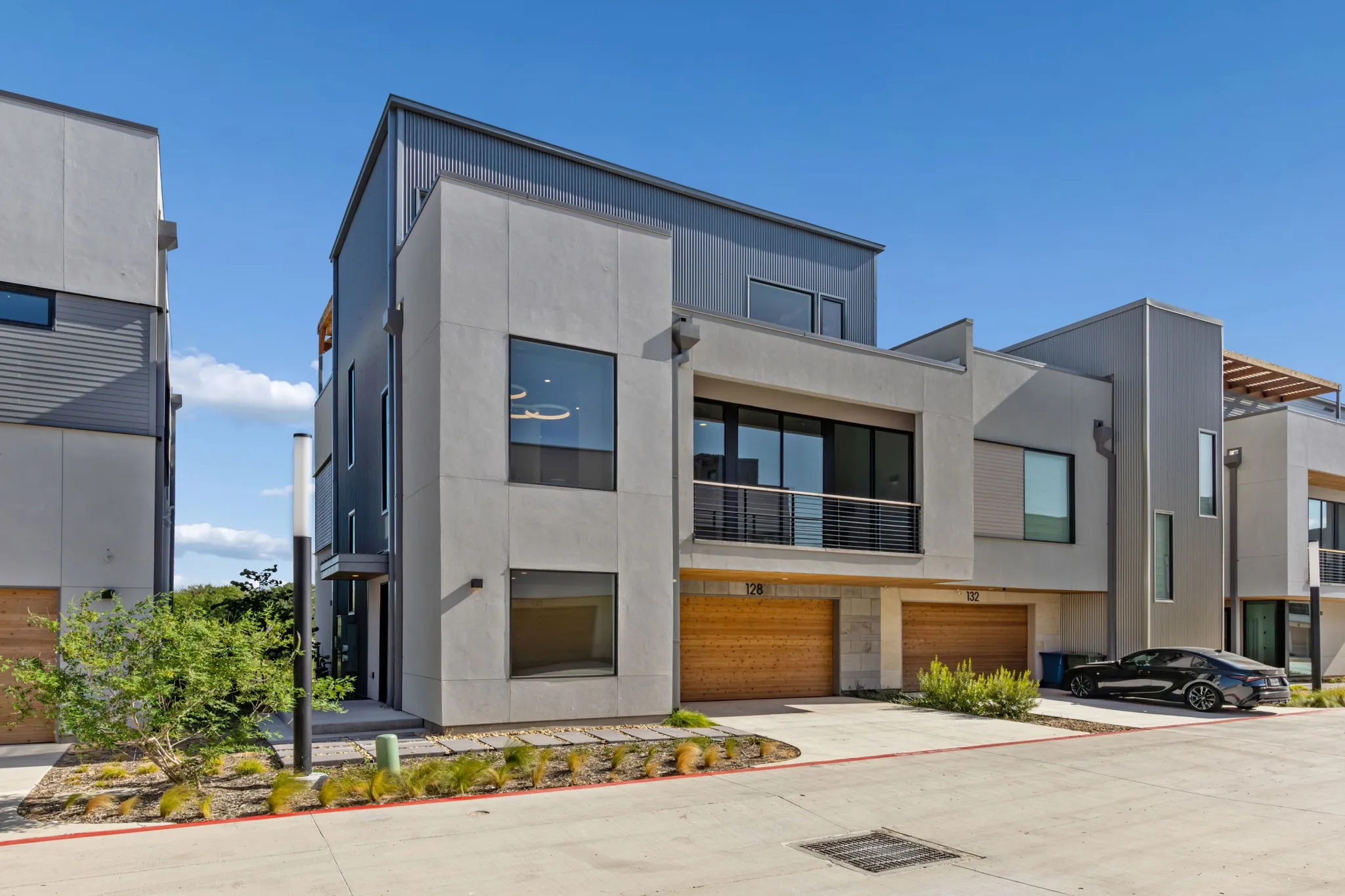 Two car garage with EV wiring.  Entrance is on the left side.  Landscaping. And affordable HOA fees.